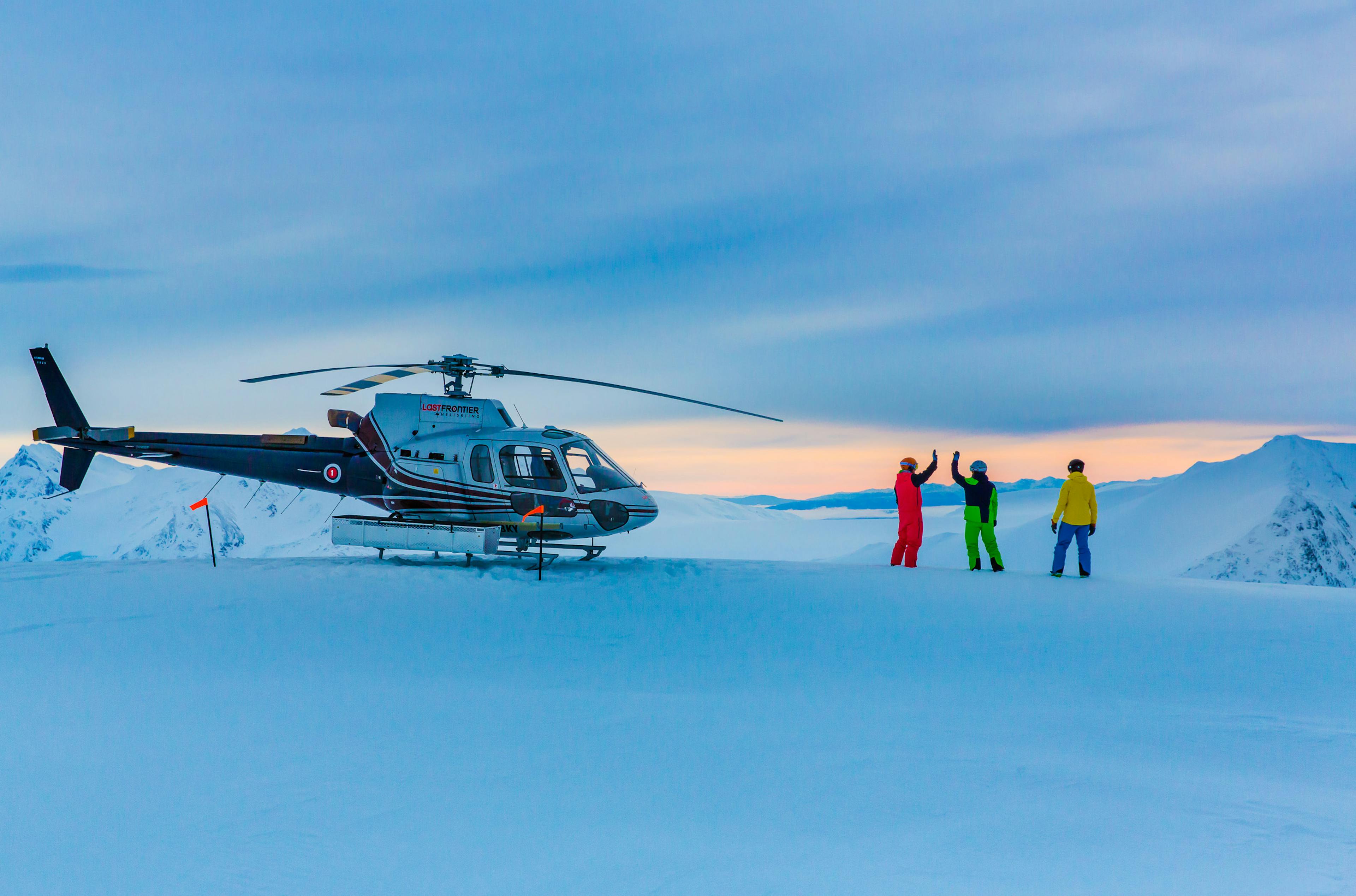 A helicopter stationed on a snowy field, highlighting the contrast between the aircraft and the white snow surrounding it.