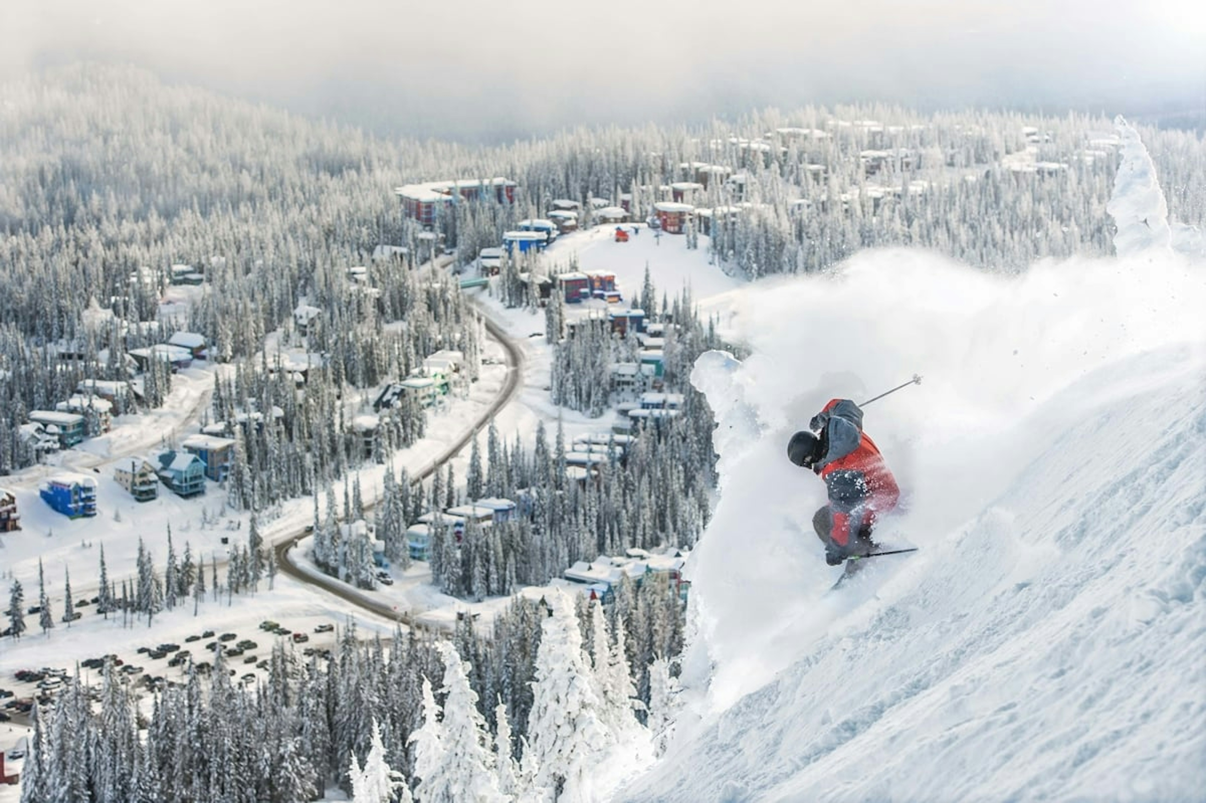 Lone skier of undiscernible gender skiing the slopes of Silver Star Mountain Resort in British Columbia, Canada