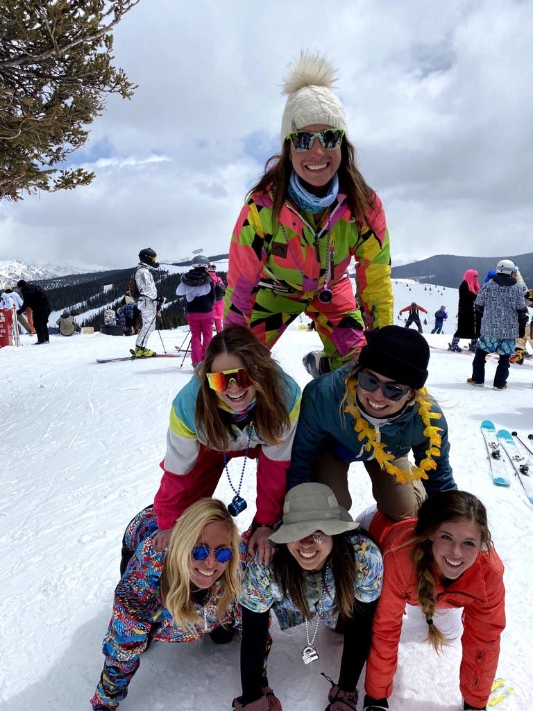 Friends forming a pyramid on the mountain.
