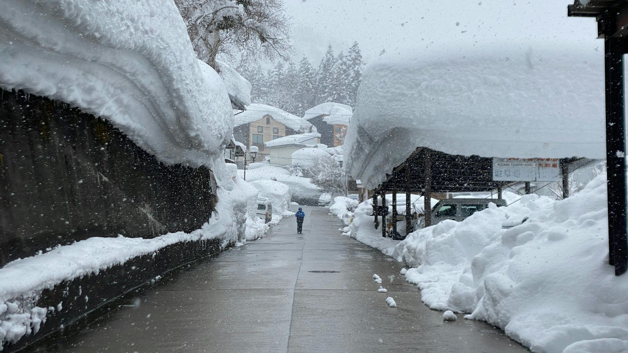 Deep powder piles on buildings in Japan.