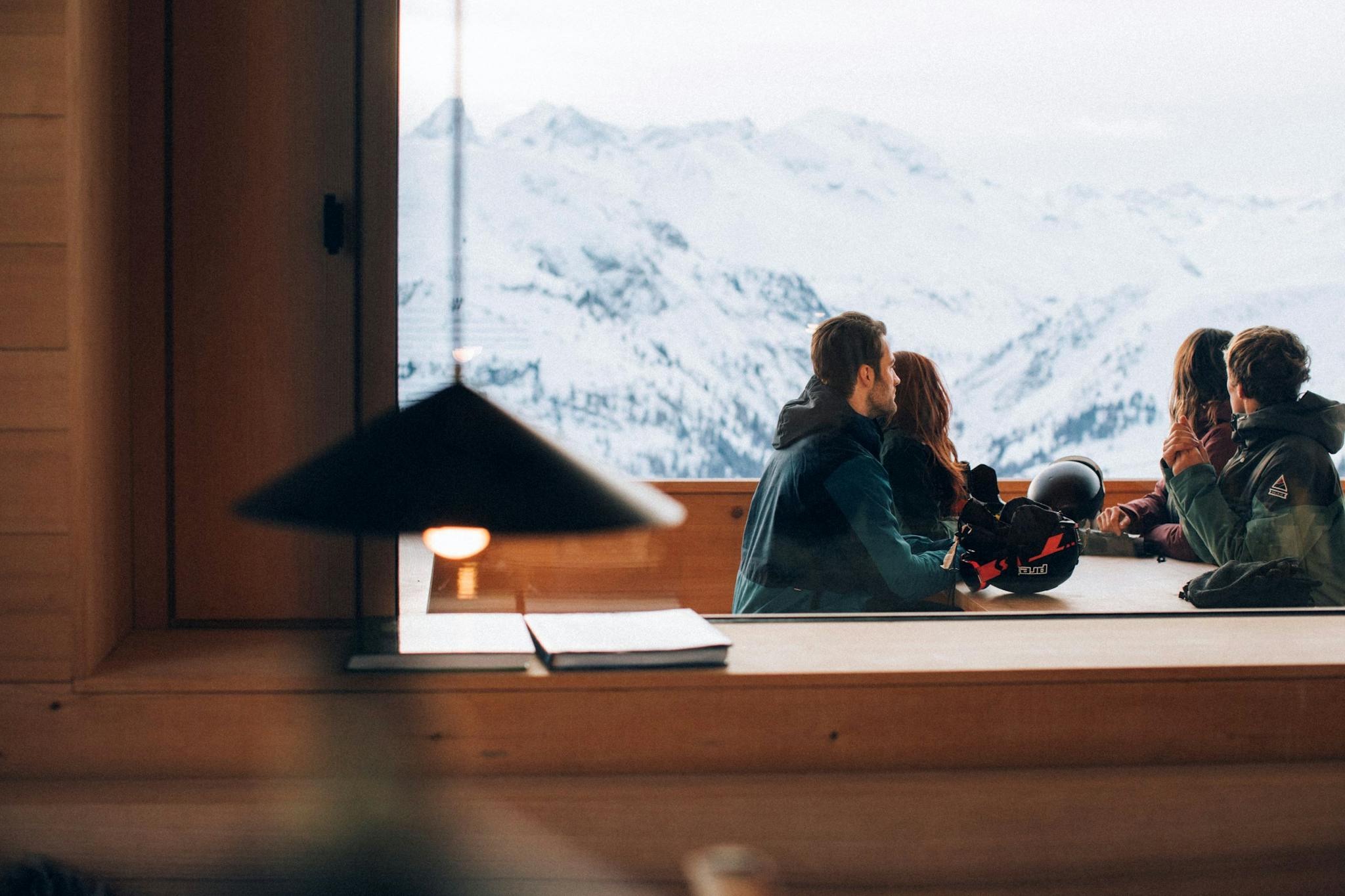 Skiers enjoying views of the Alps during their après.