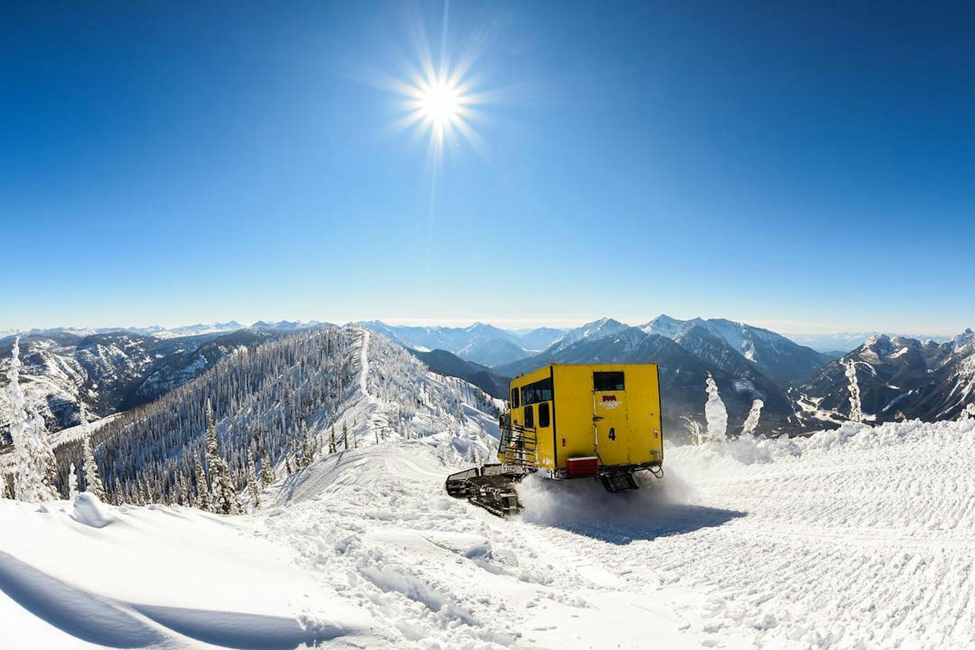 A landscape shot of a snowcat in the beautiful Canadian wilderness.