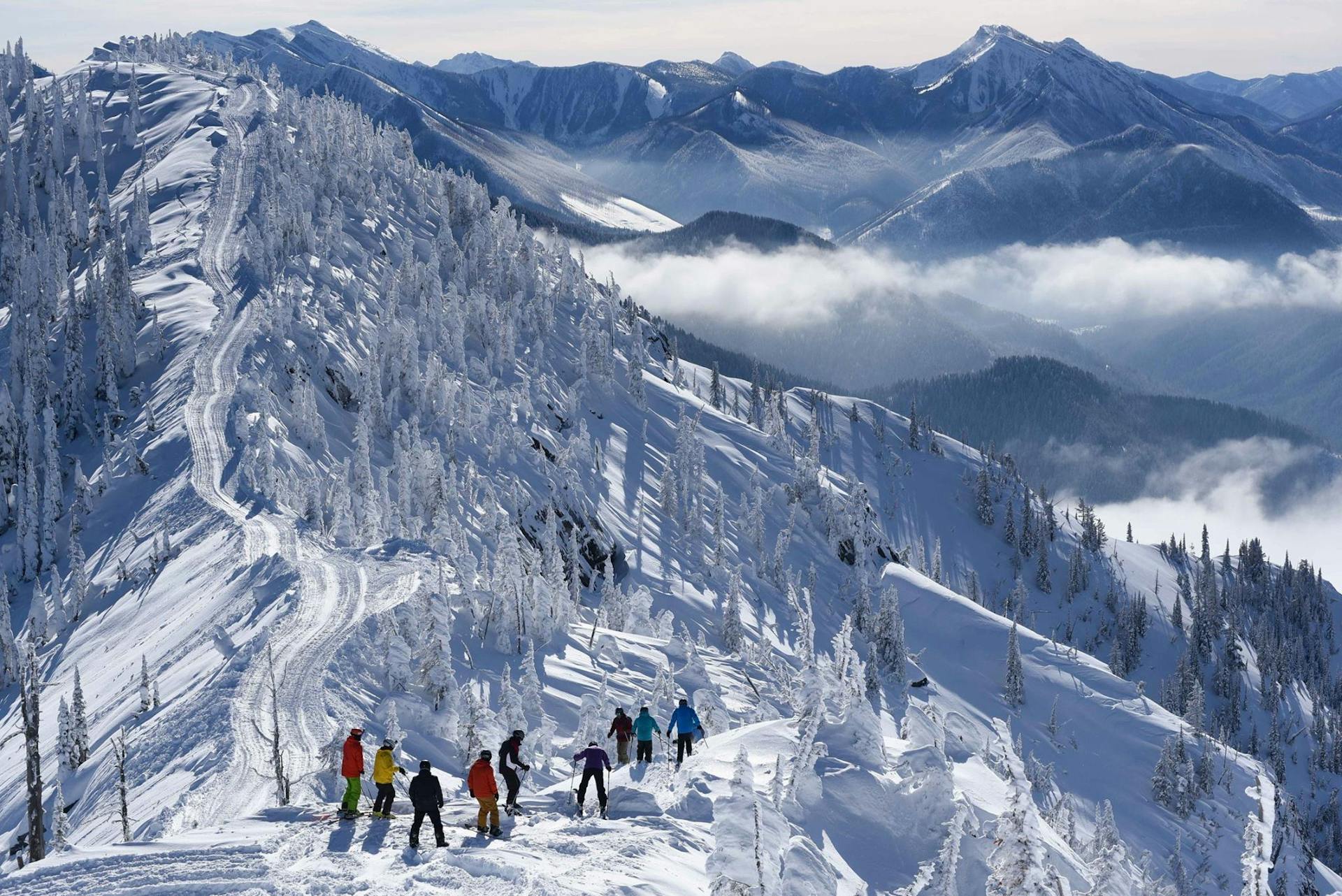 Landscape shot of skiers on a cat skiing adventure in Canada.