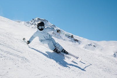 A skier descends a snowy slope