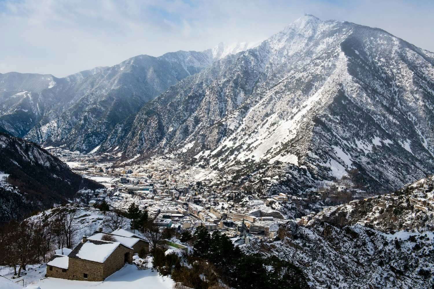 Aerial perspective of Grandvalria village in Andorras mountains, featuring picturesque landscapes and serene rural life.