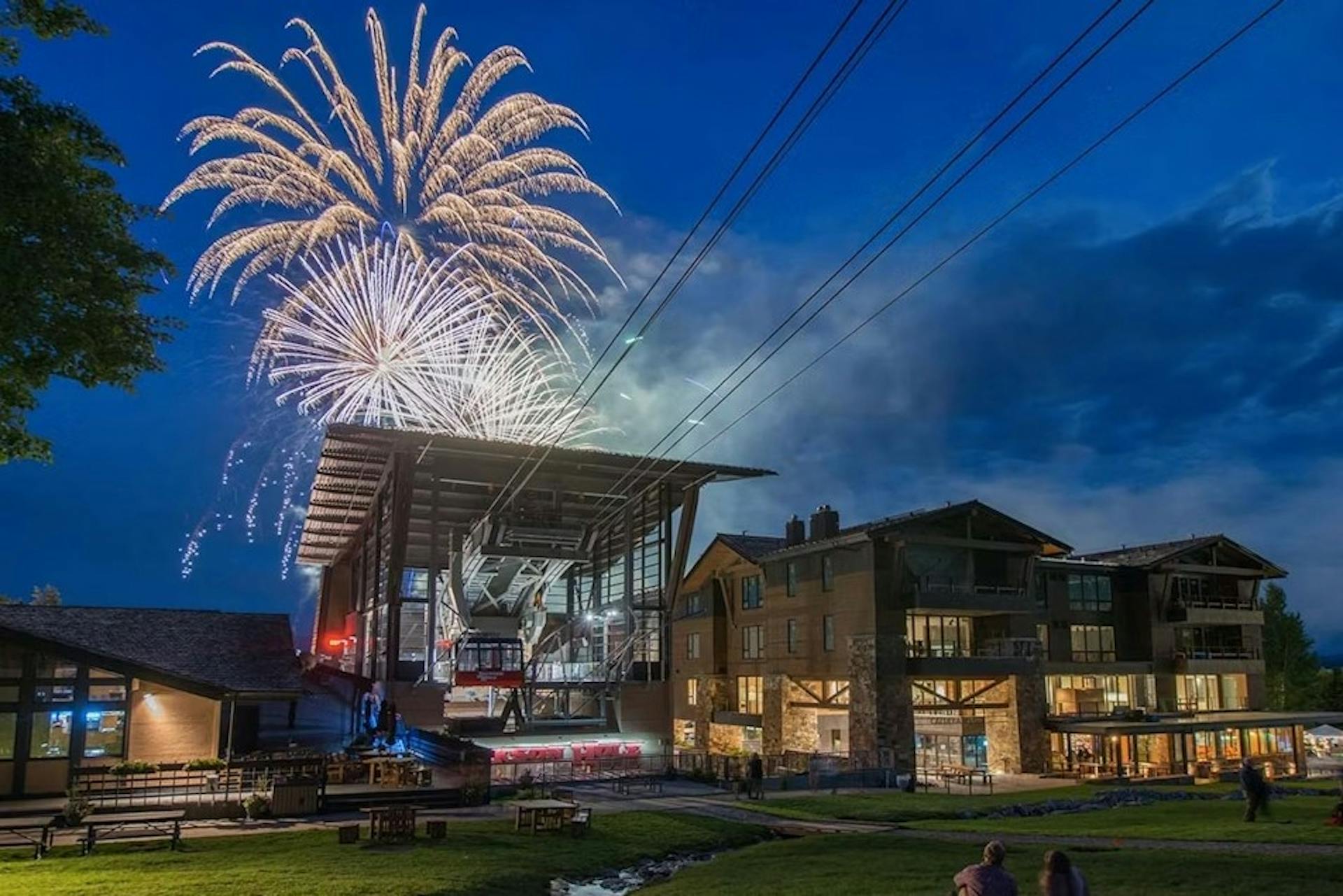 Fireworks burst over a twilight sky in Teton Village at Jackson Hole