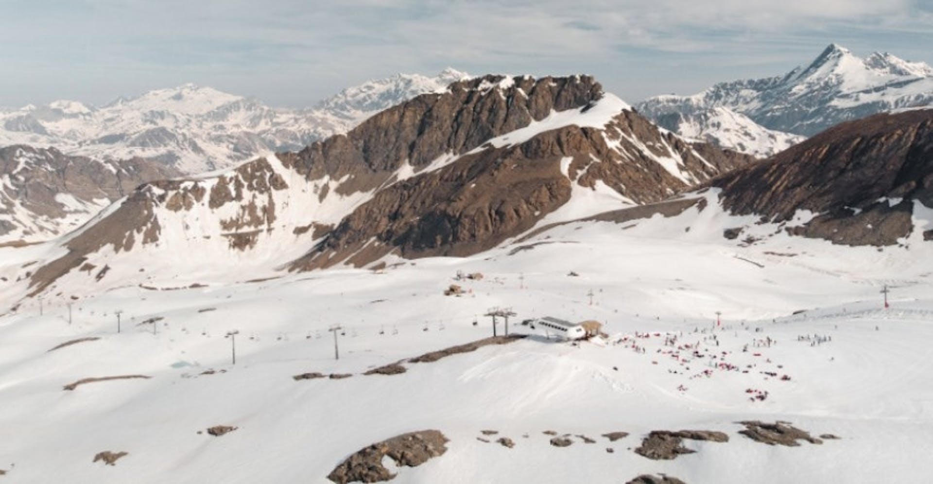 Bird's eye view of the snowy slopes and alpine mountains of Val d'Isère Ski Resort
