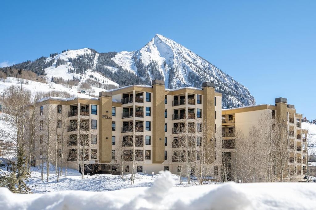 Exterior of The Plaza Condominiums by Crested Butte Mountain Resorts in winter