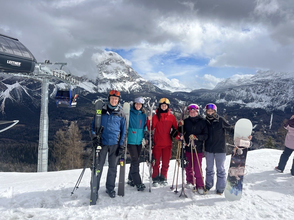 The Ski.com team posing in front of the mountains of Faloria
