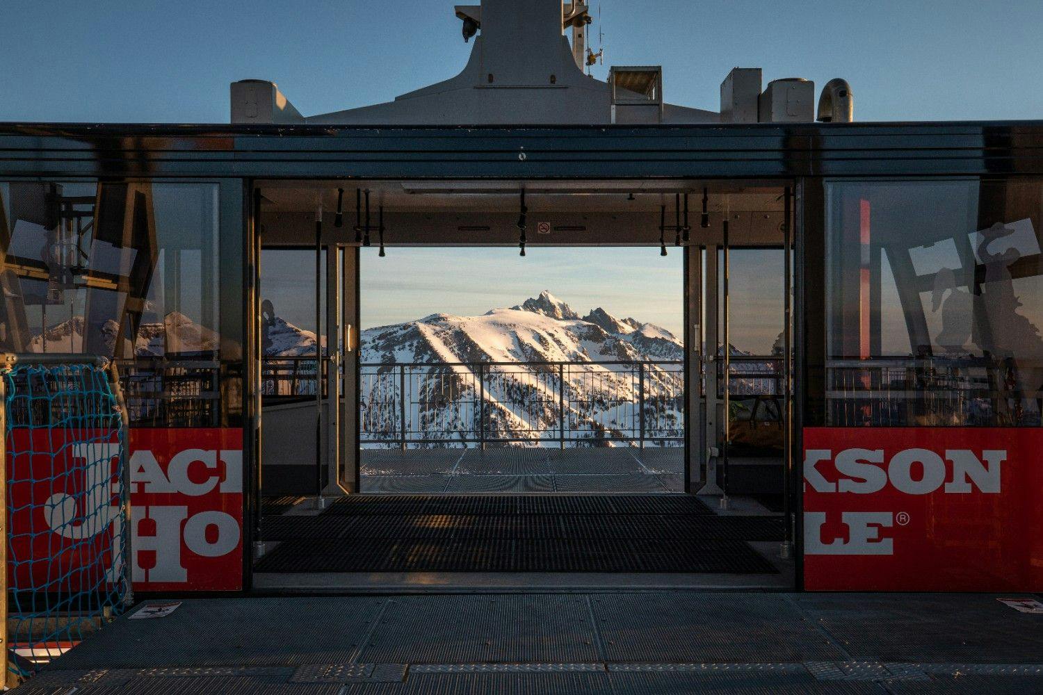 Jackson Hole Tram with open doors and a beautiful view of the snowy alpine mountains
