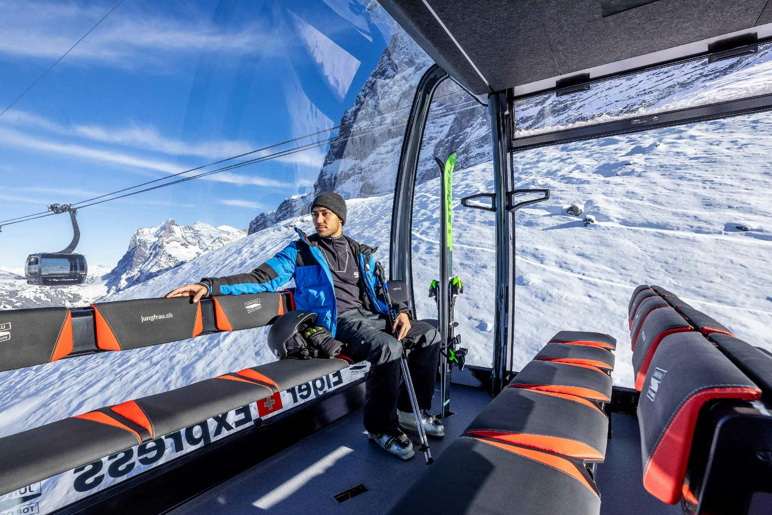 Skier riding the gondola near Interlaken in the Jungfrau region of Switzerland.