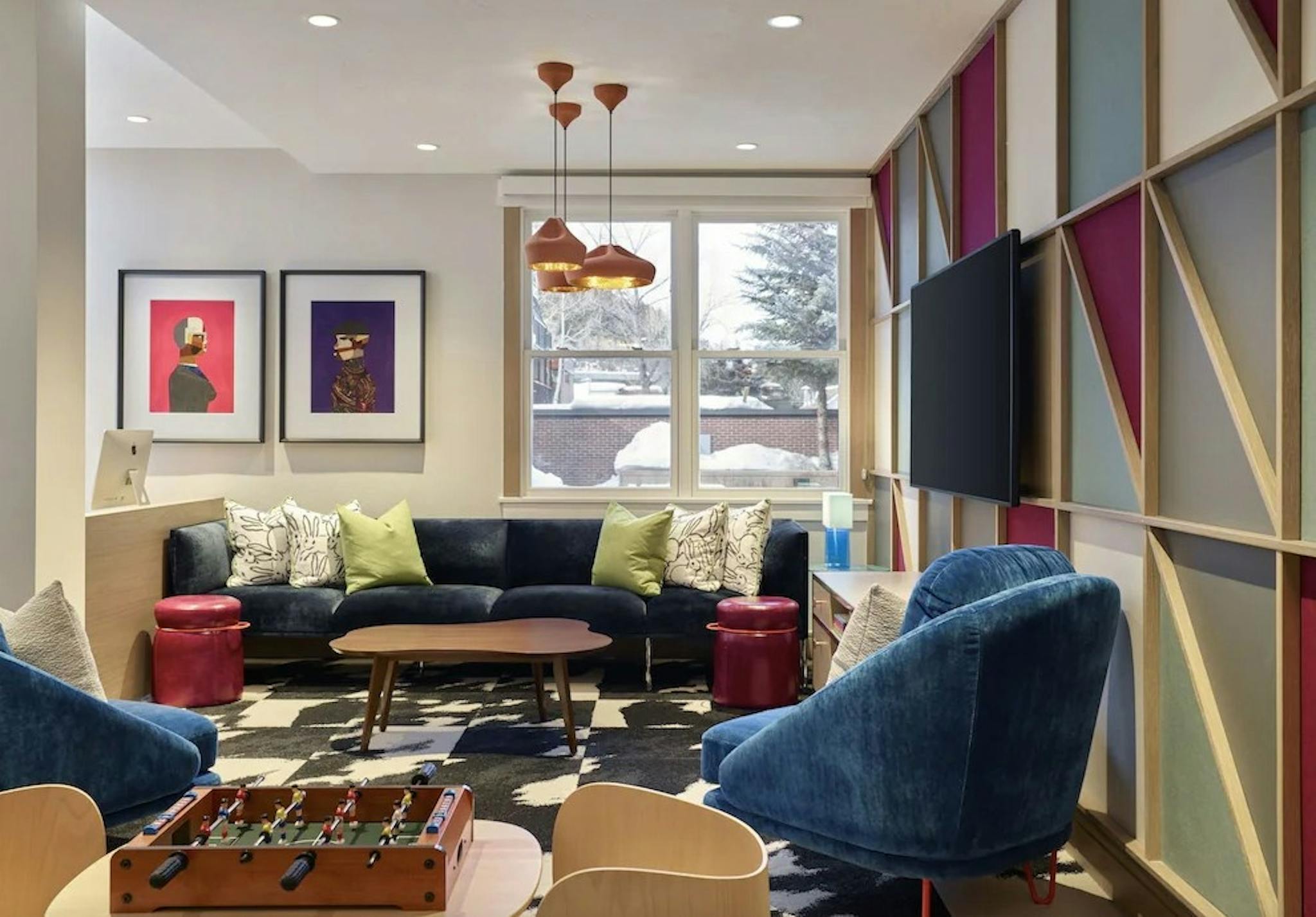 Modern furniture and foosball table in the playroom at the Limelight Hotel
