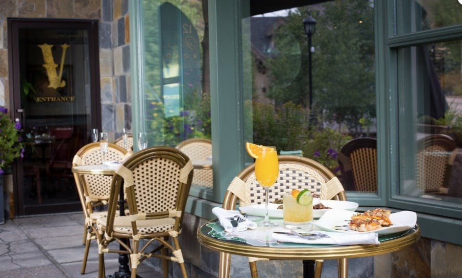 Fancy drinks and a plate full of food out on the patio of the Vintage cafe in Vail