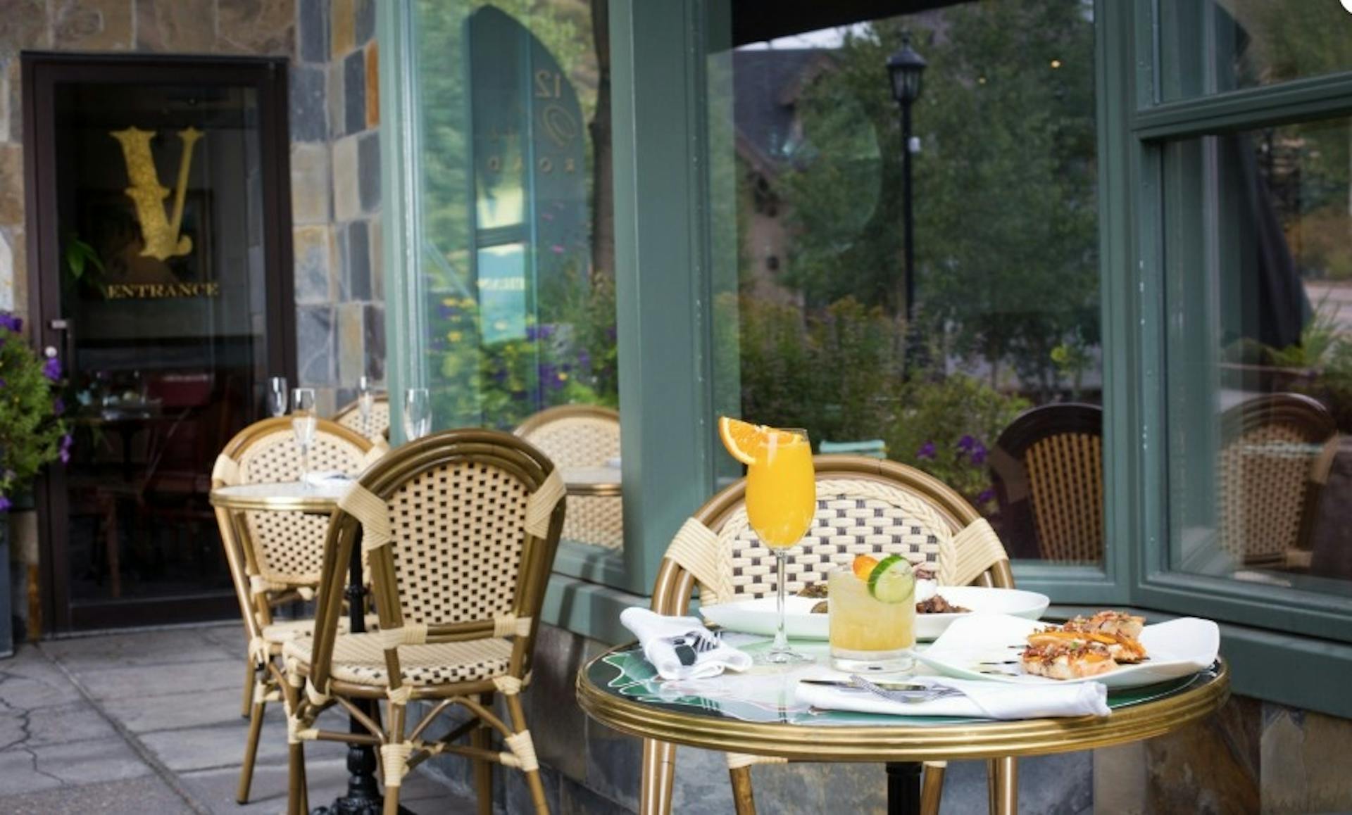 Fancy drinks and a plate full of food out on the patio of the Vintage cafe in Vail