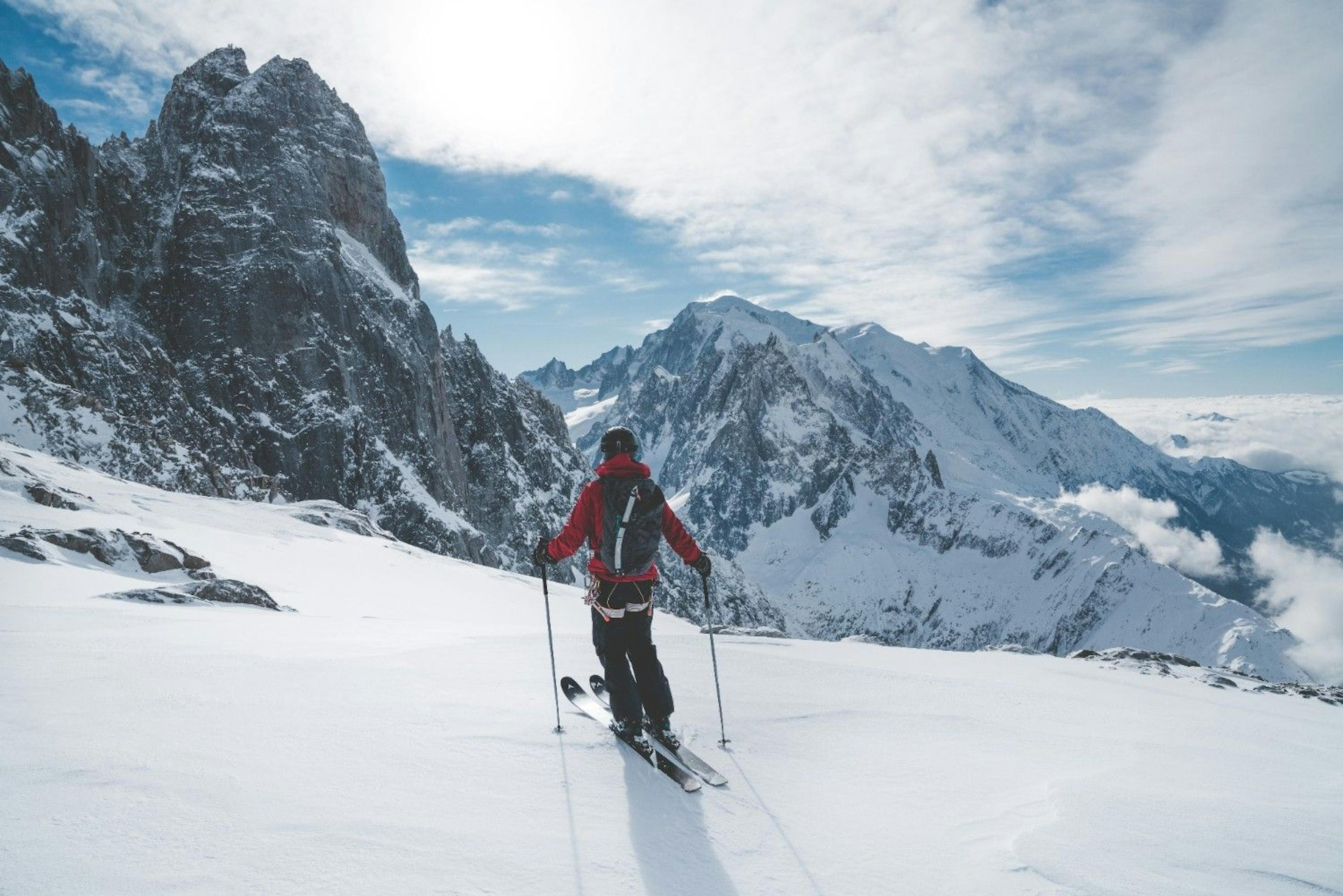 skier looking a beautiful snowy alpine mountains at Chamonix Resort