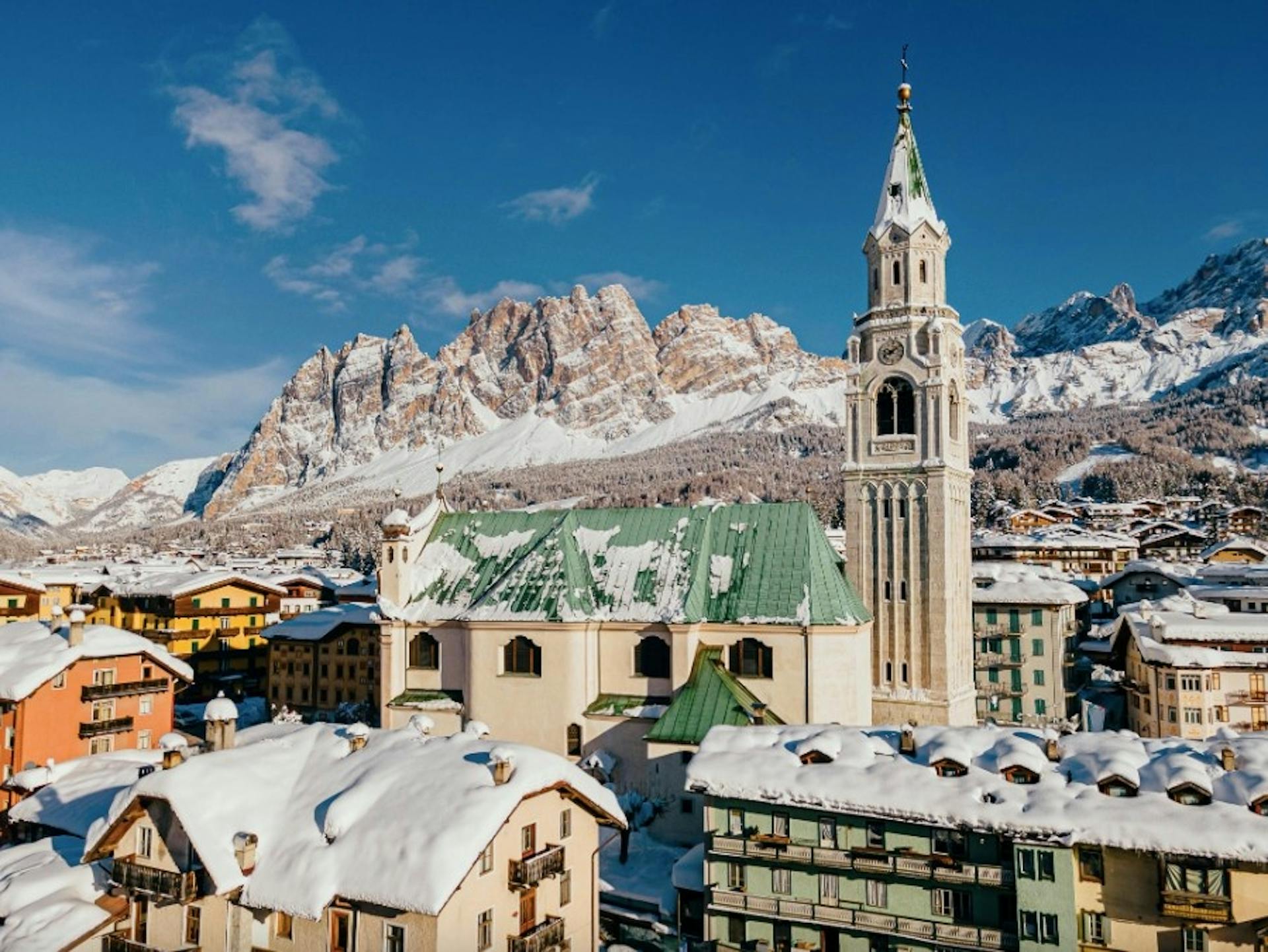 The snowy town of Cortina d’Ampezzo, Italy with snow-covered alpine mountains in the background