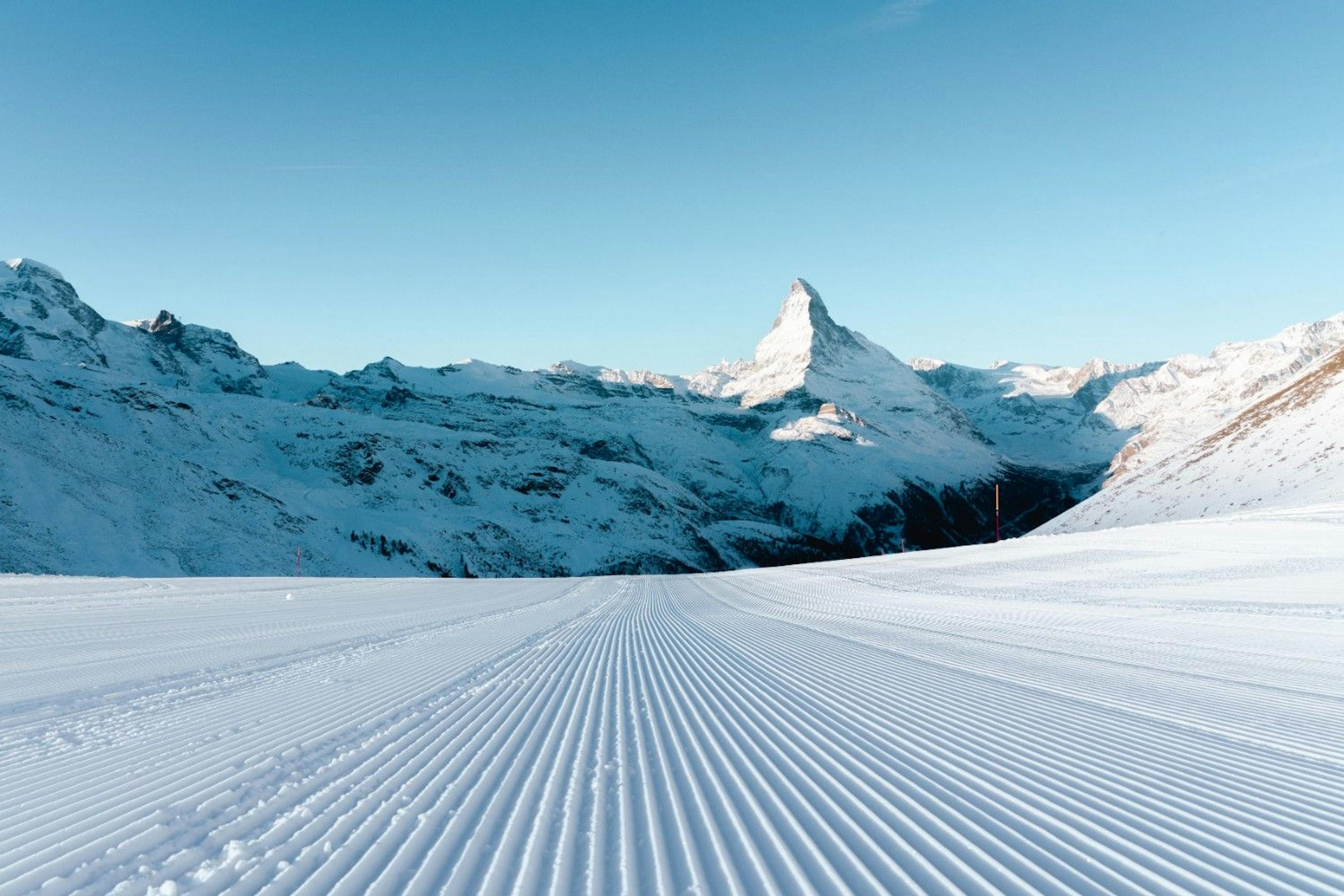 A freshly groomed Zermatt ski run overlooking the snow-covered Matterhorn mountain