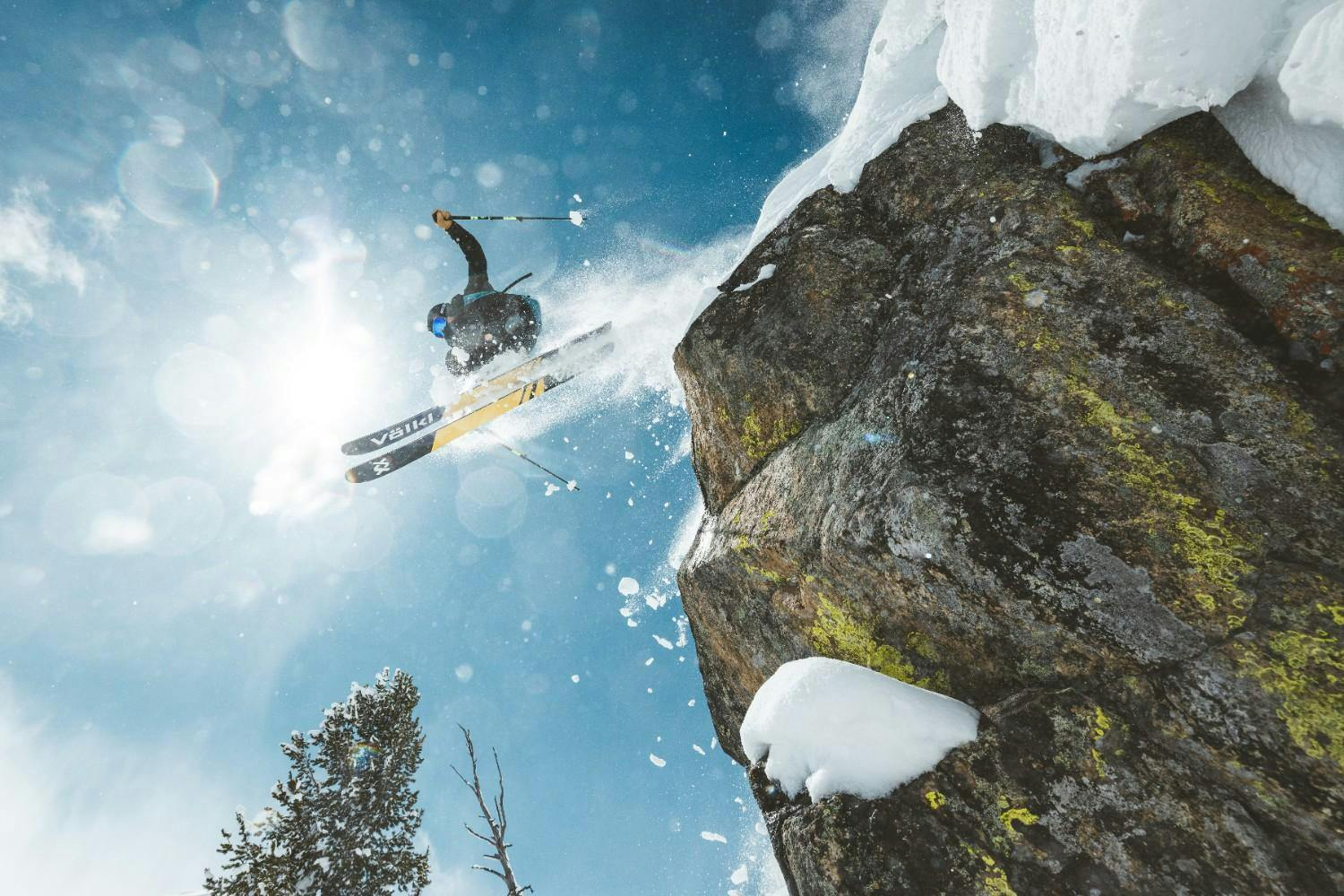 Skier jumping off a cliff on a bluebird day at Jackson Hole Resort