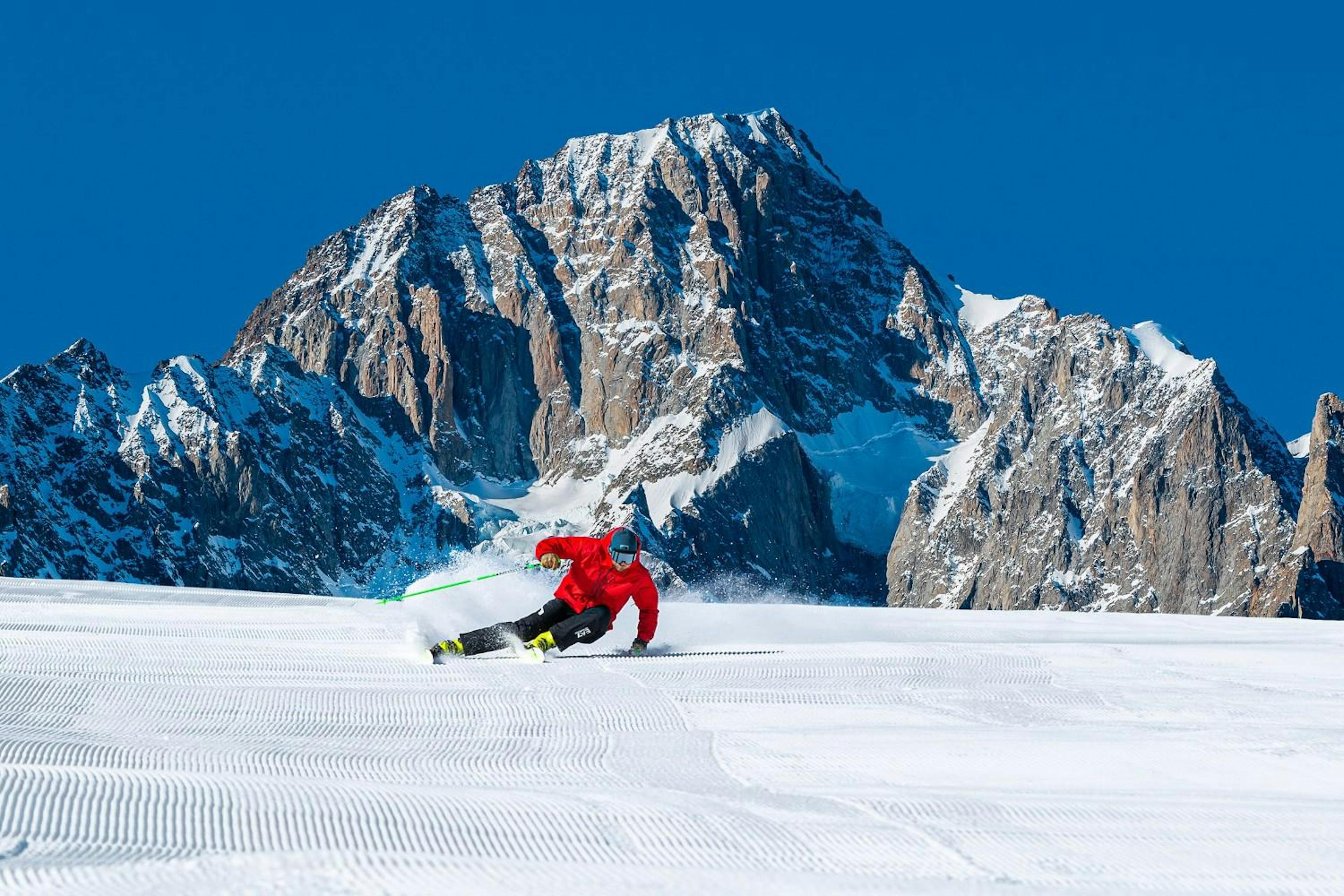 Skier carving a turn on a groomed run at Courmayeur Resort Mont Blanc