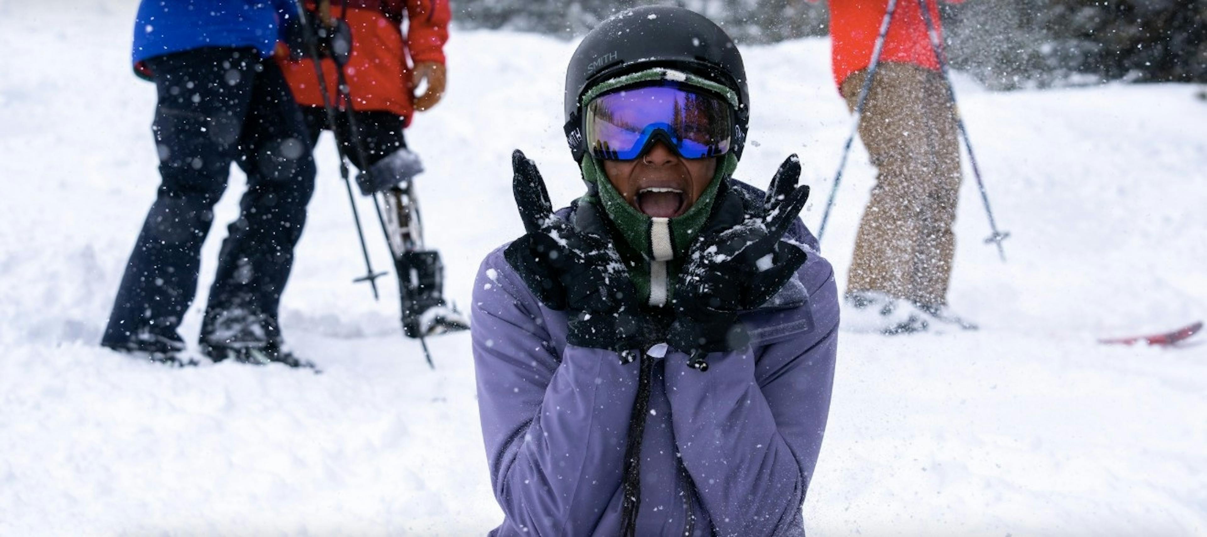Snowboarder smiles with joy on a snowy day at Winter Park Resort