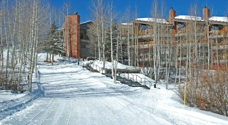 Groomed ski-in ski-out access slope outside of the Woodrun V Lodge at Aspen Snowmass