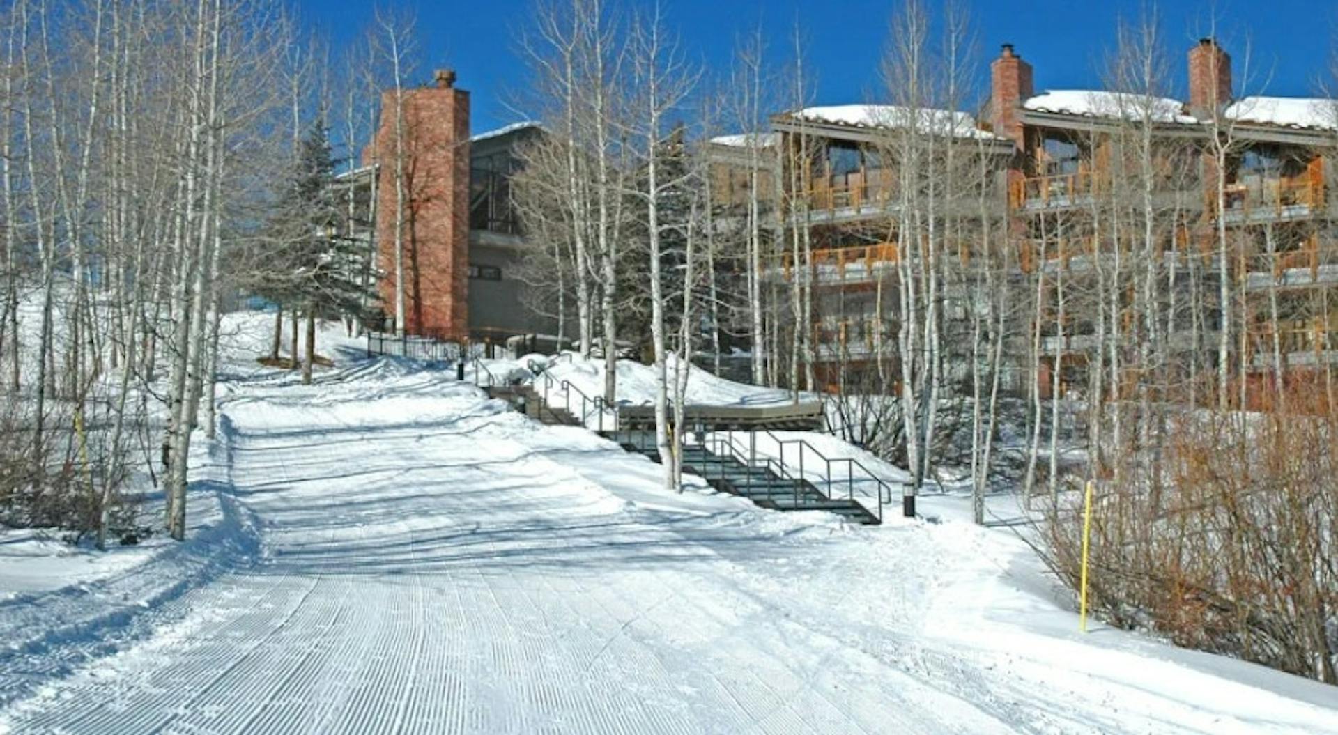 Groomed ski-in ski-out access slope outside of the Woodrun V Lodge at Aspen Snowmass