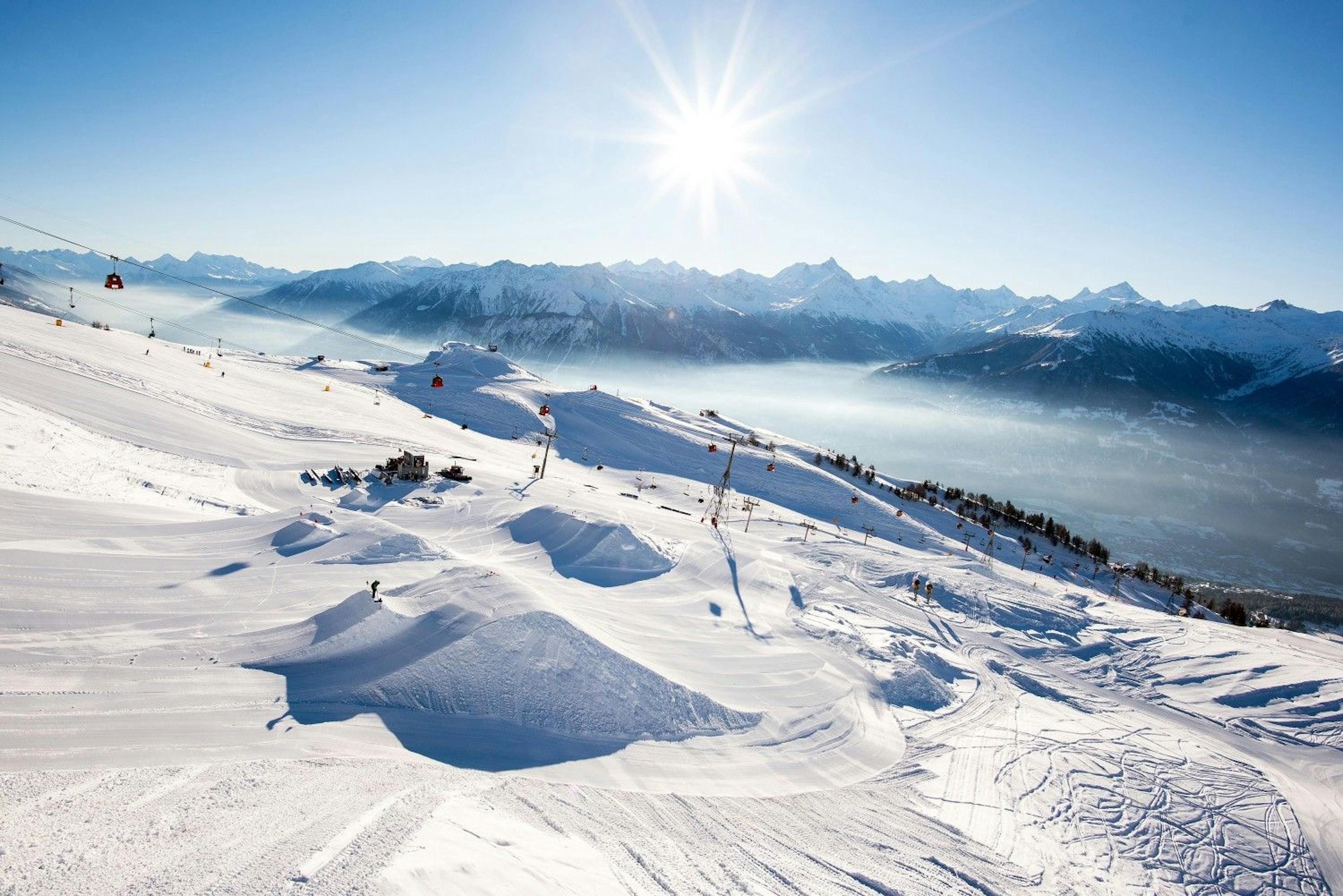 Sunny winter afternoon over the slopes of Crans Montana in Switzerland, Europe.
