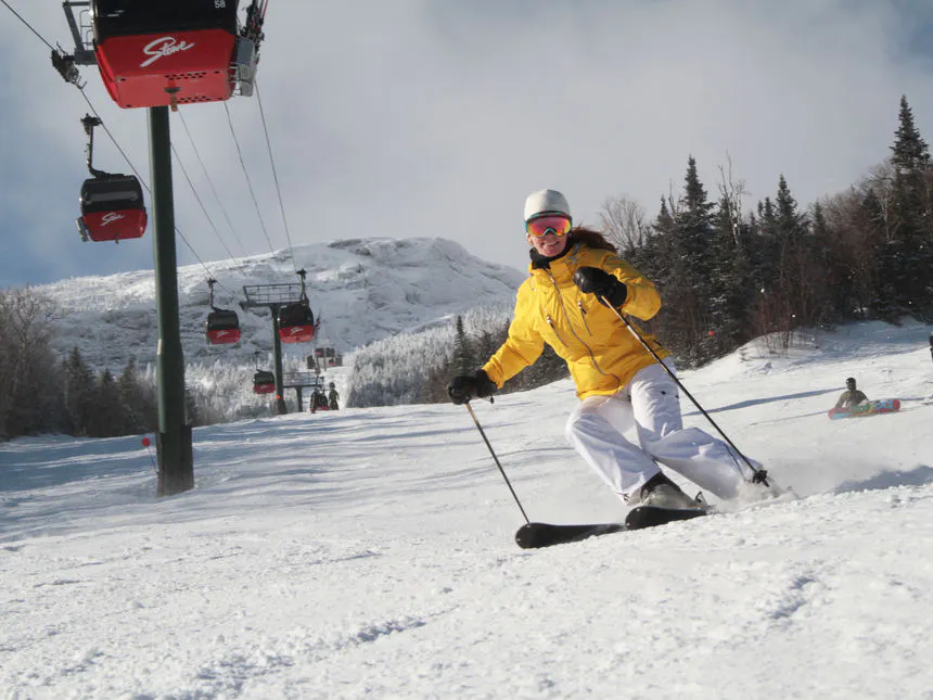 Skiing beneath the signature red gondola at Stowe