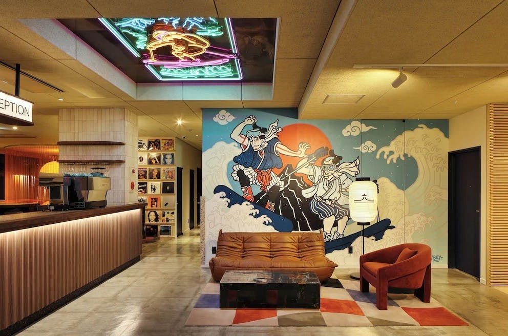 Reception of Evo Hotel Hakuba with colorful Japanese art on the walls