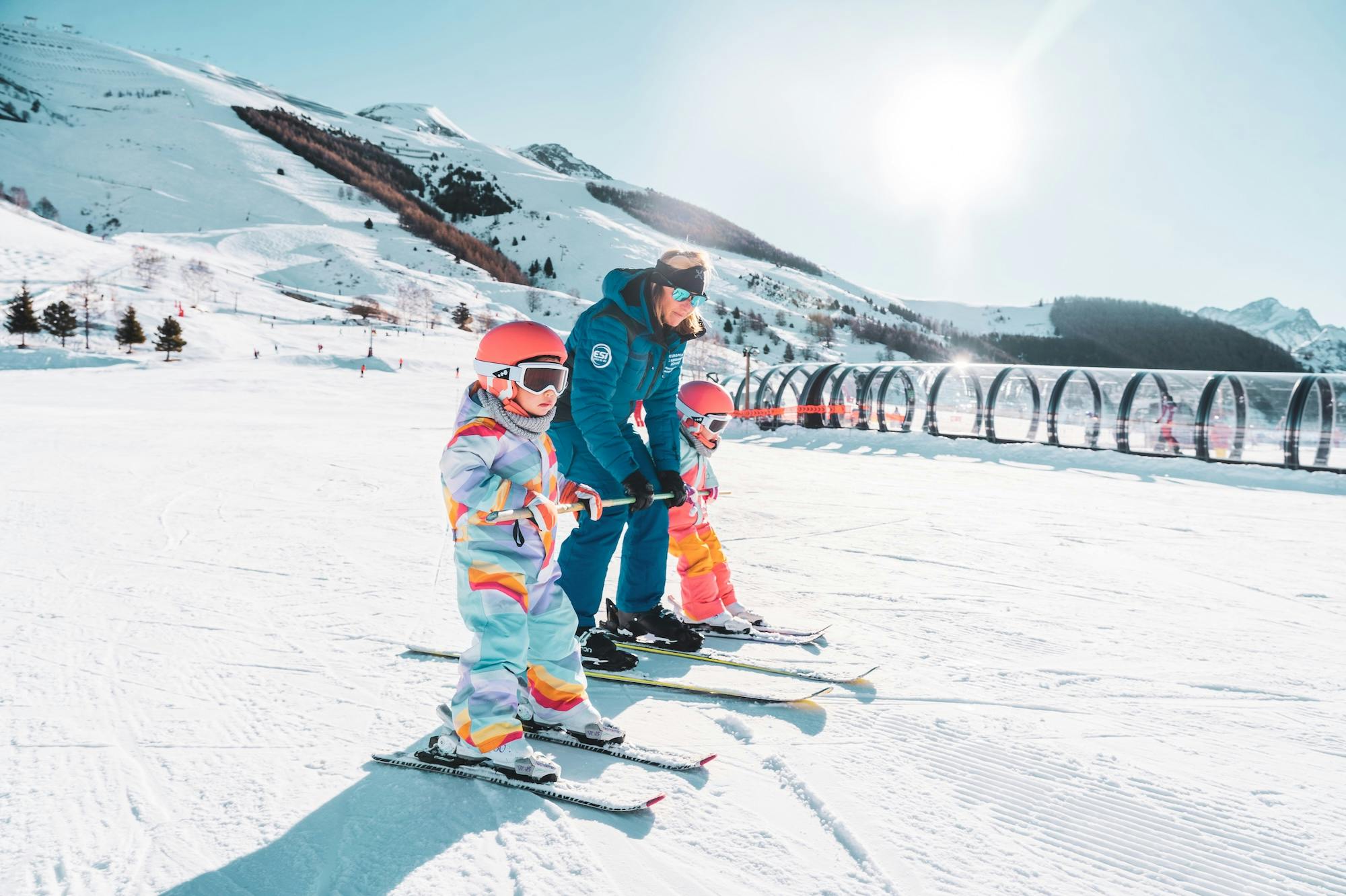 a family enjoying skiing together on a snowy slope.