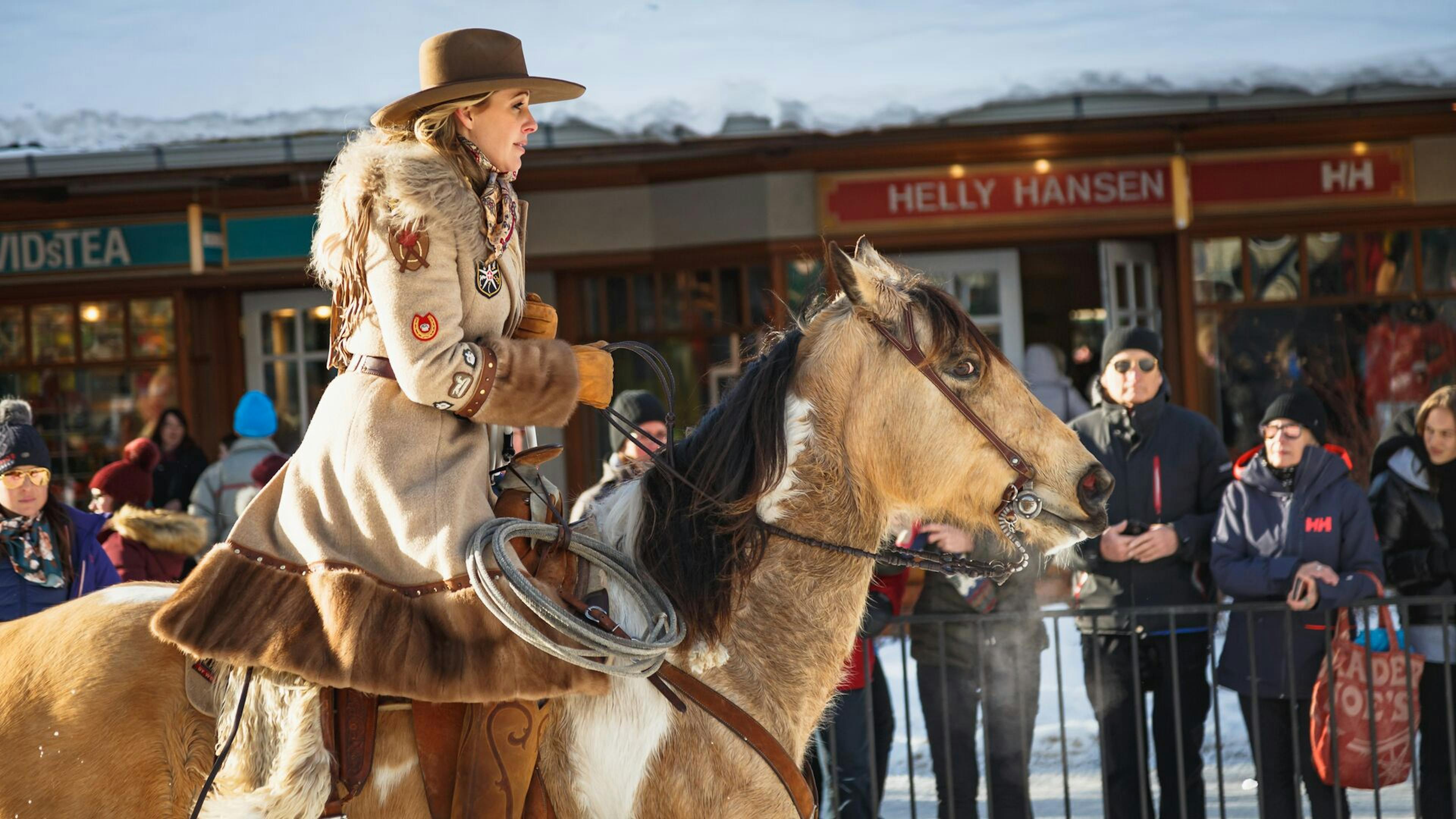 Alberta cowgirl Skijoring on a horse down Banff Avenue