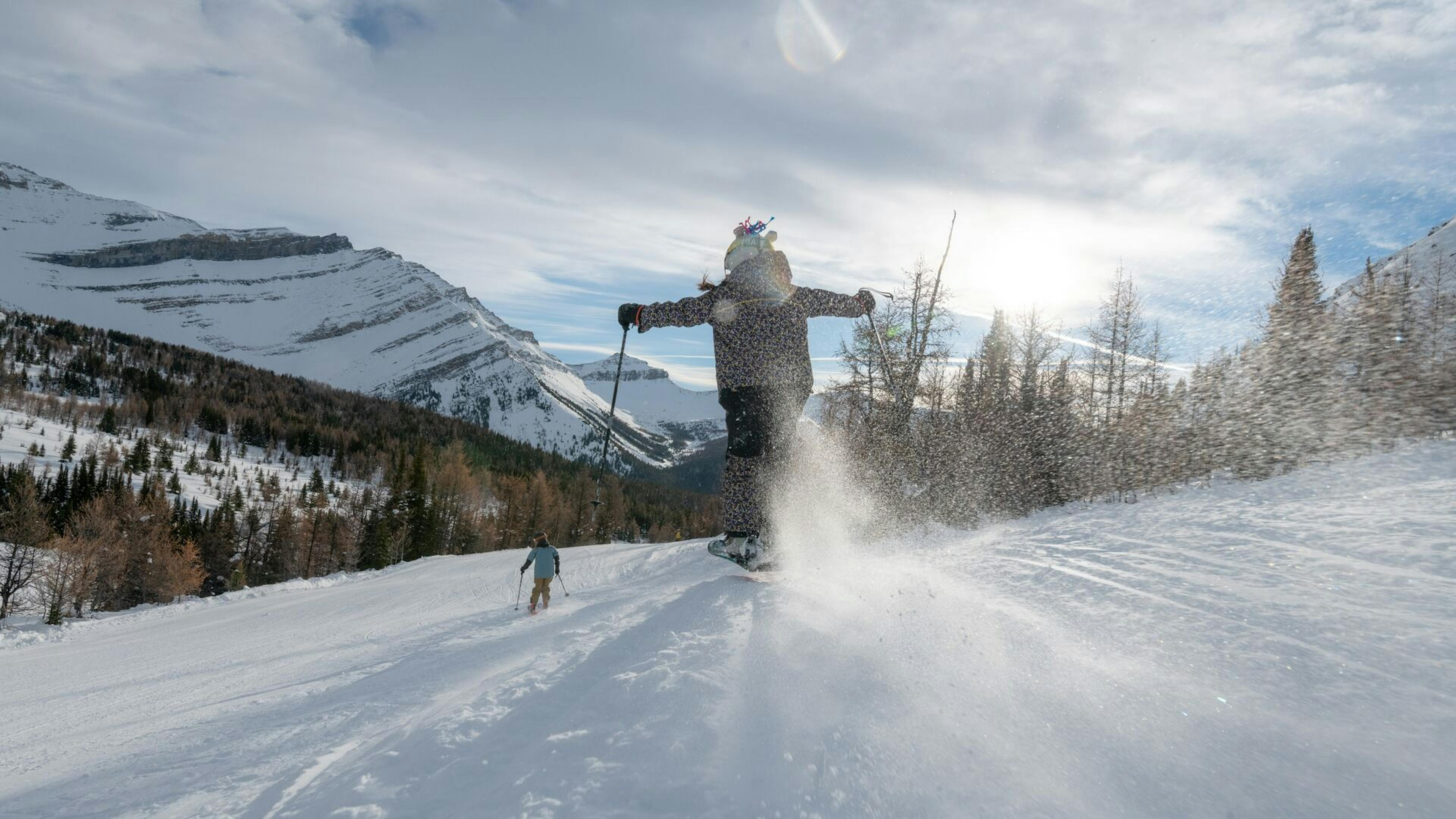 Two skiers bombing down the slopes at Lake Louise Ski Resort