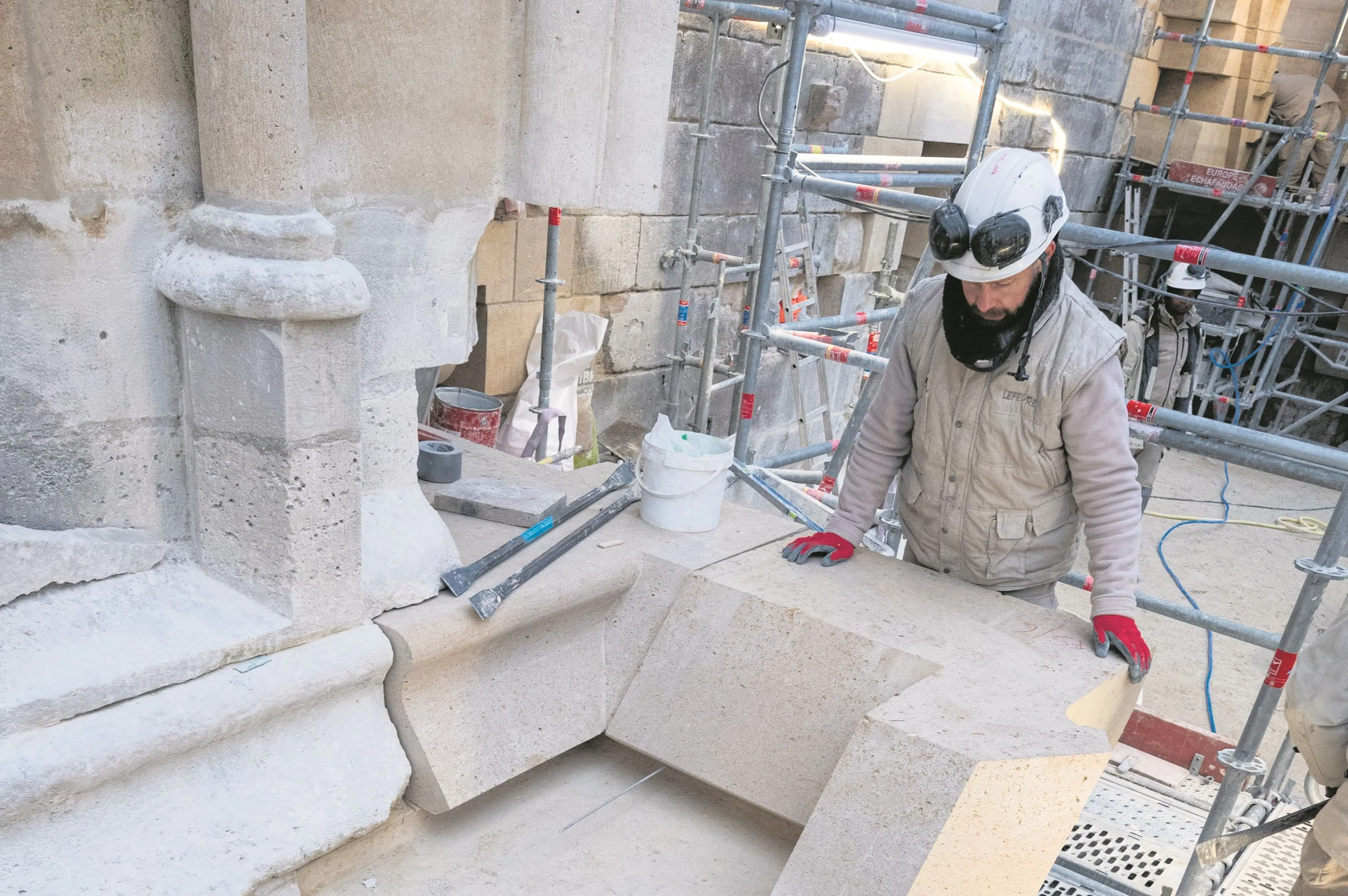 Tailleur de pierre au travail sur un chantier de restauration de monument