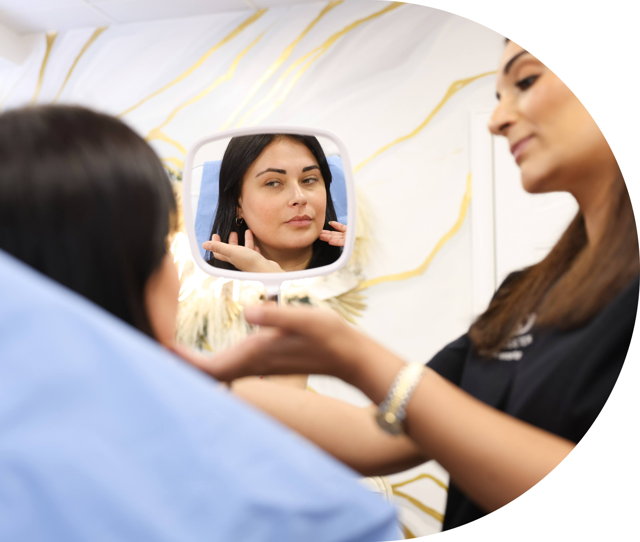 A patient looking in the mirror at her results