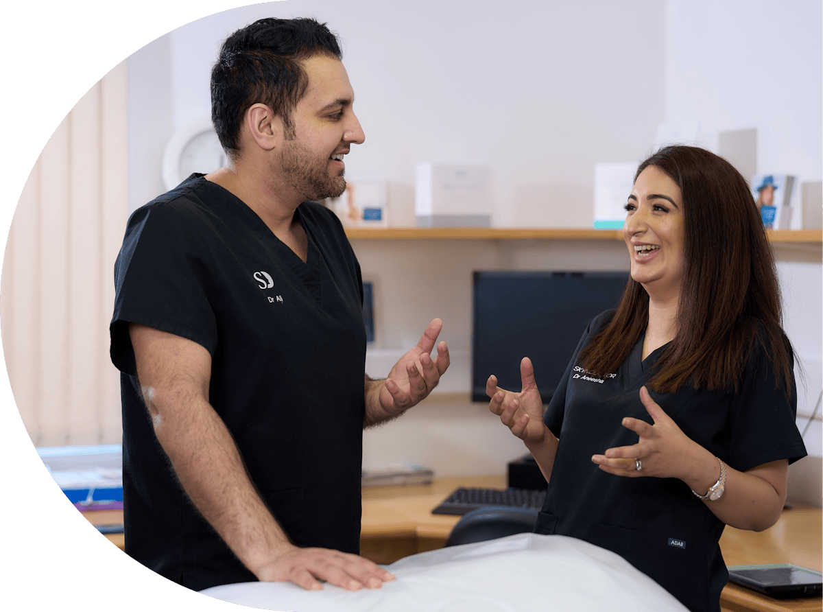 Dr Aneesha laughing with her team member