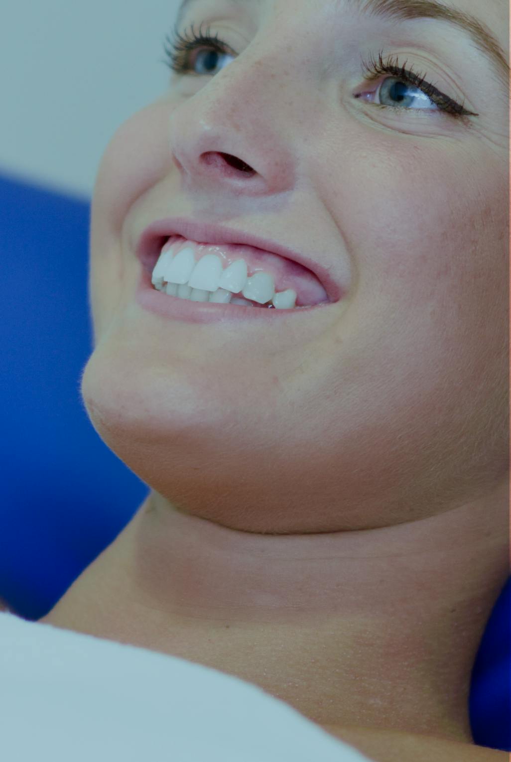 woman smiling on a treatment chair