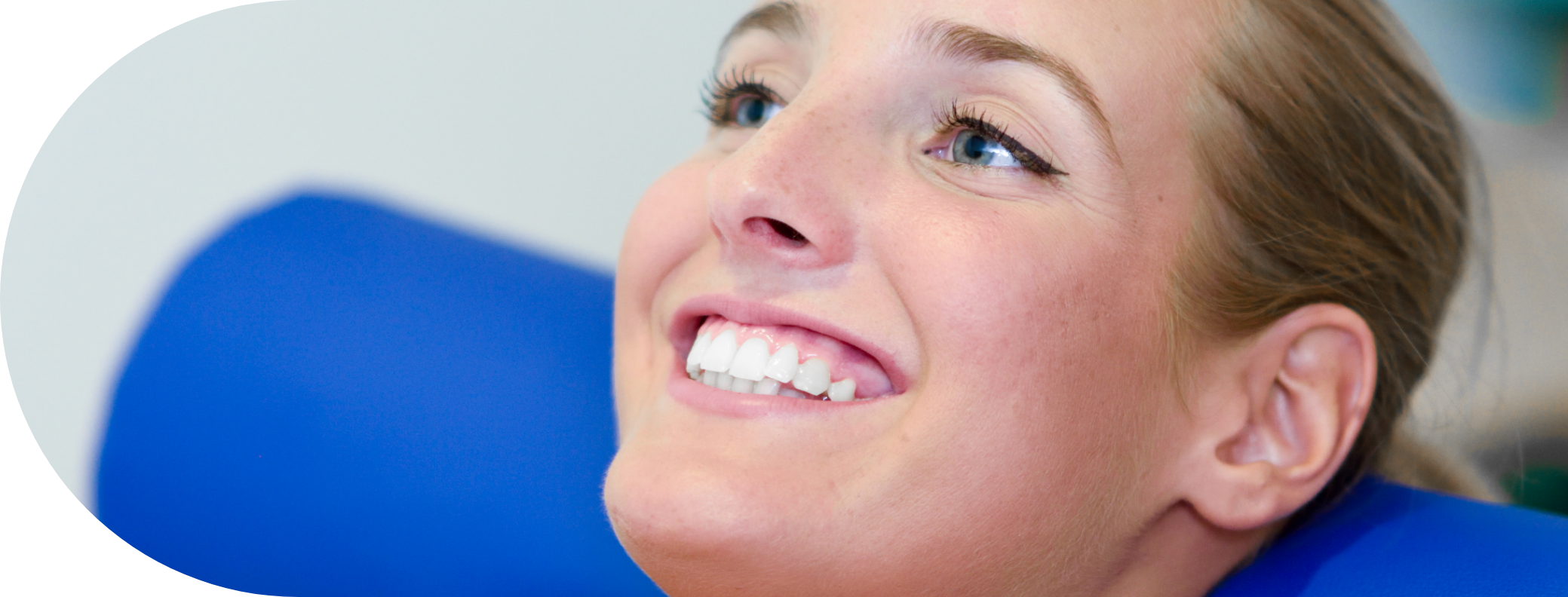 woman smiling on a treatment chair