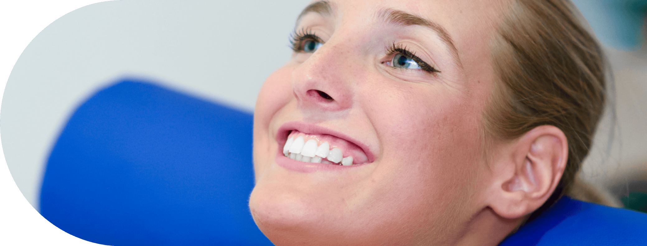 woman smiling on a treatment chair