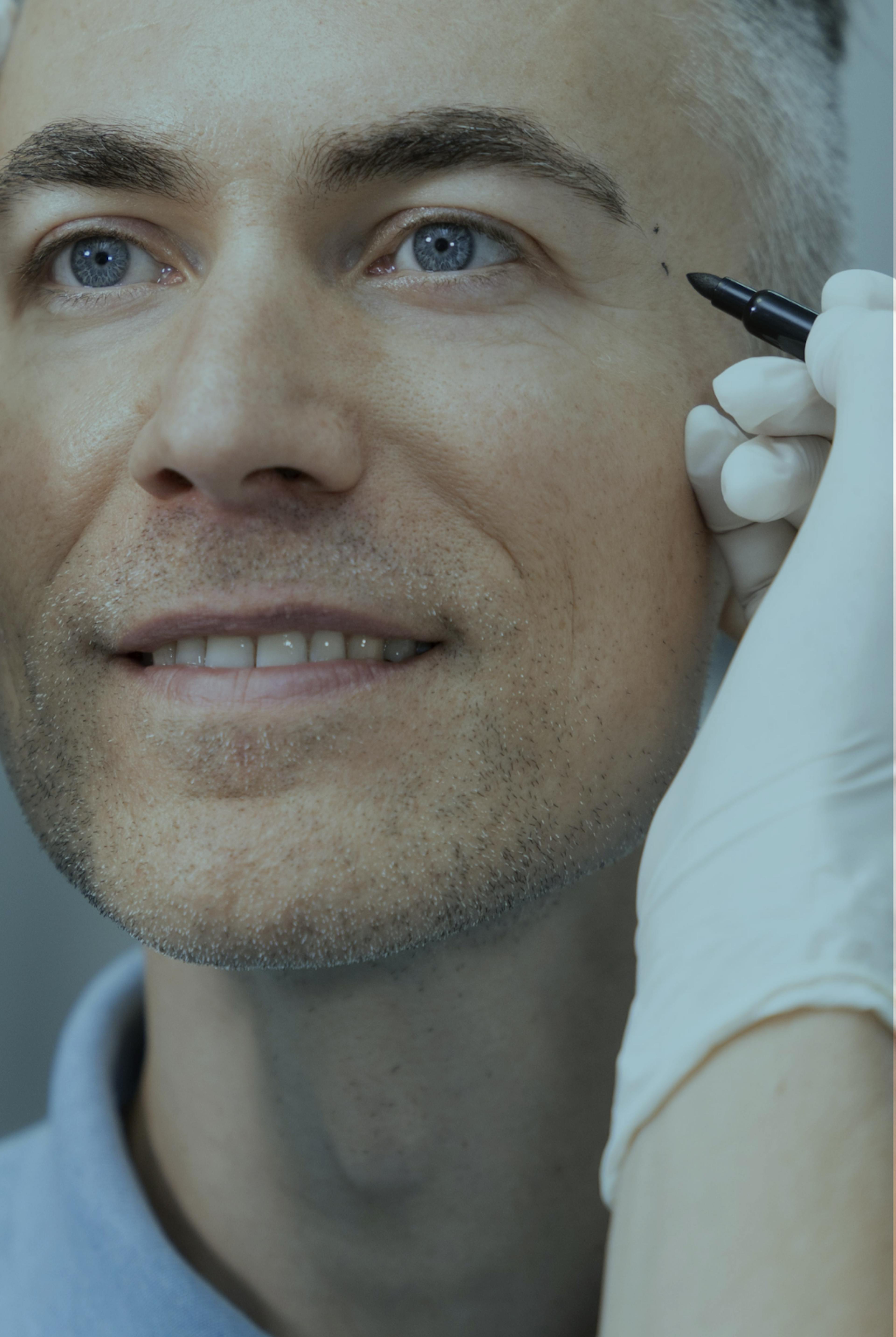 man having his temple examined