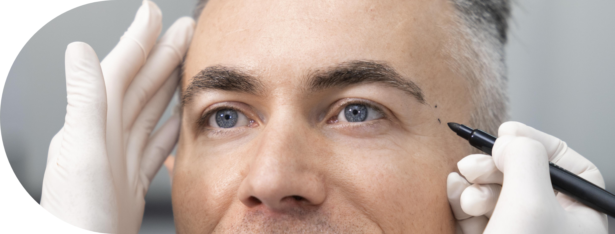 man having his temple examined