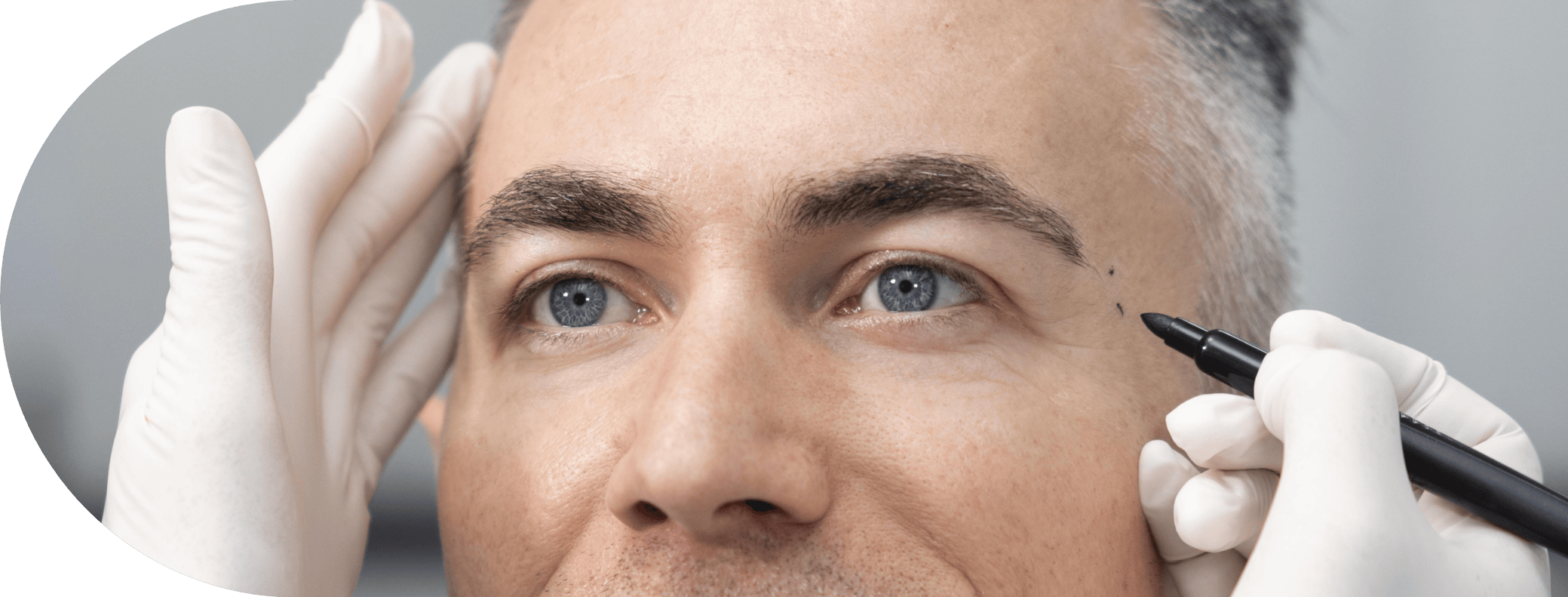 man having his temple examined