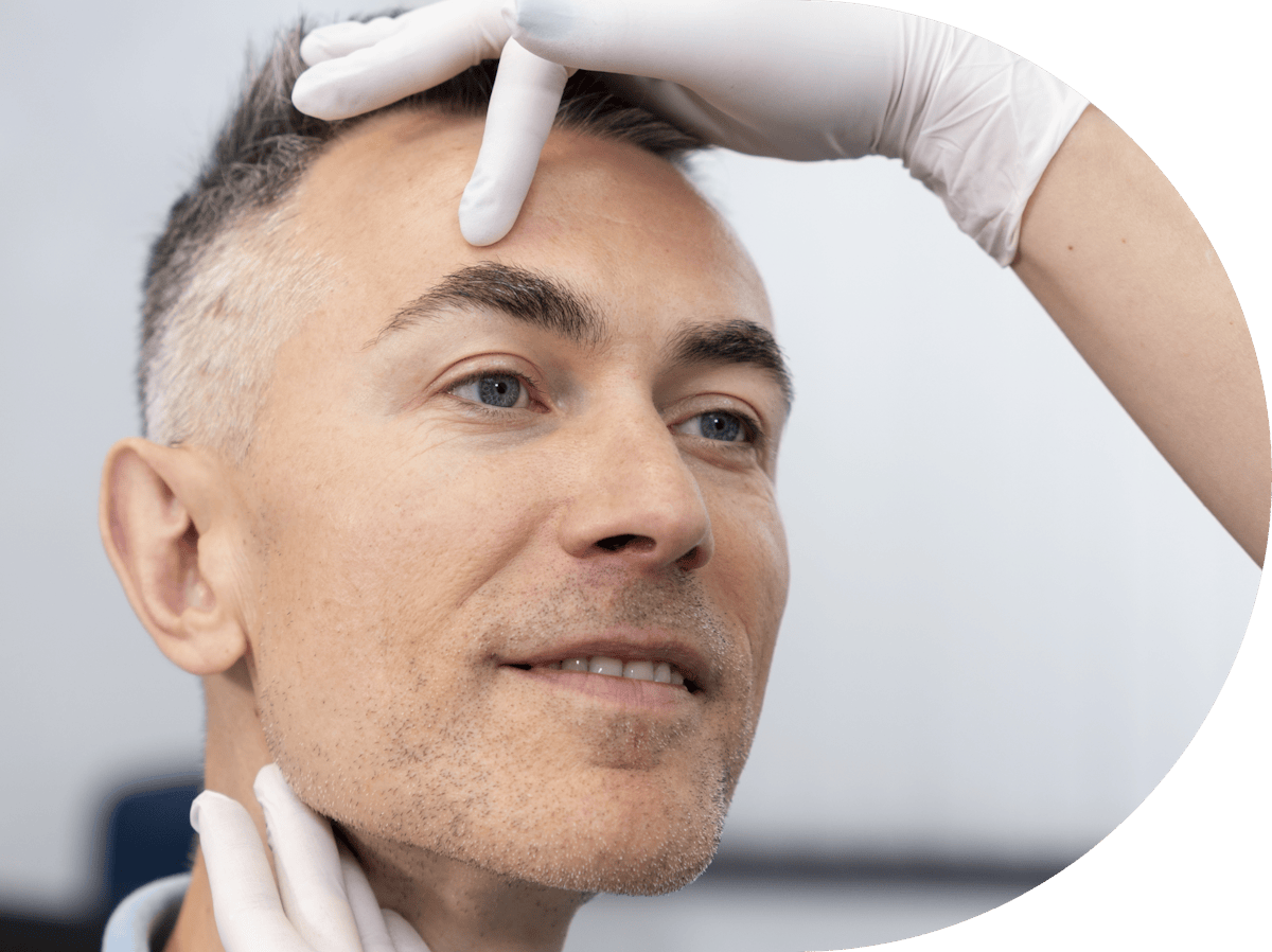 man having his temple examined