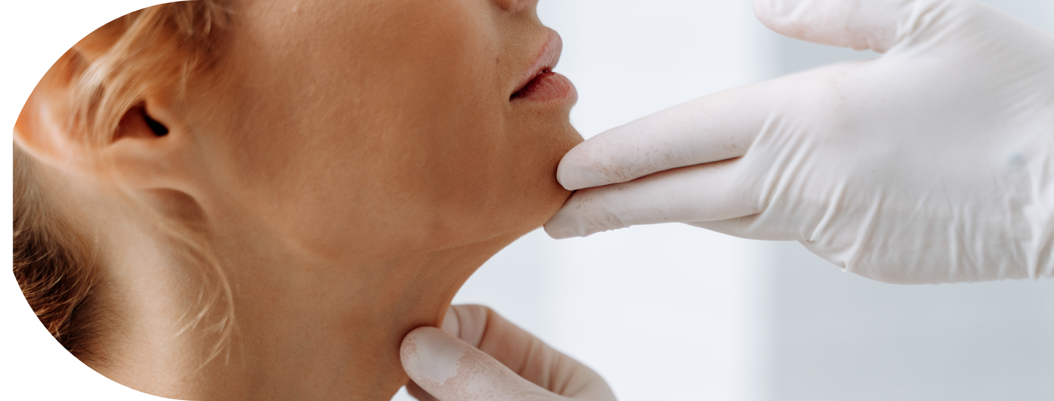 woman having her chin examined
