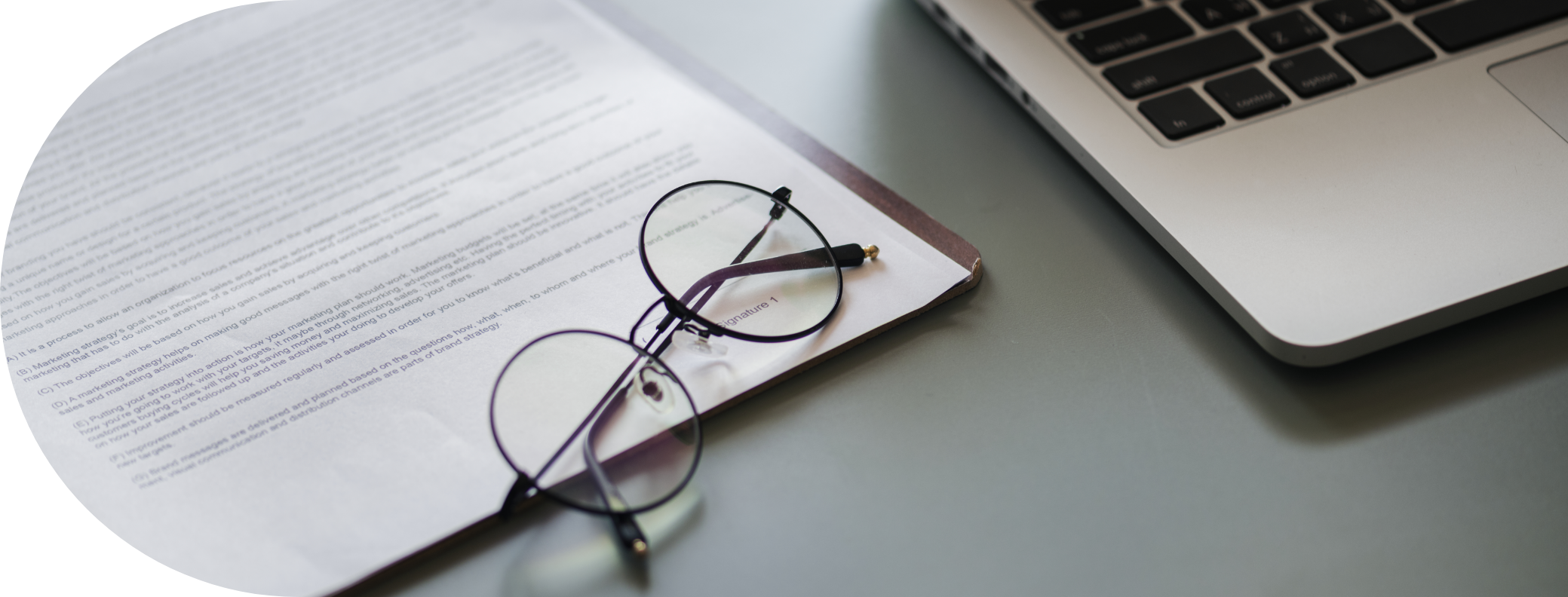 legal papers with glasses and a laptop