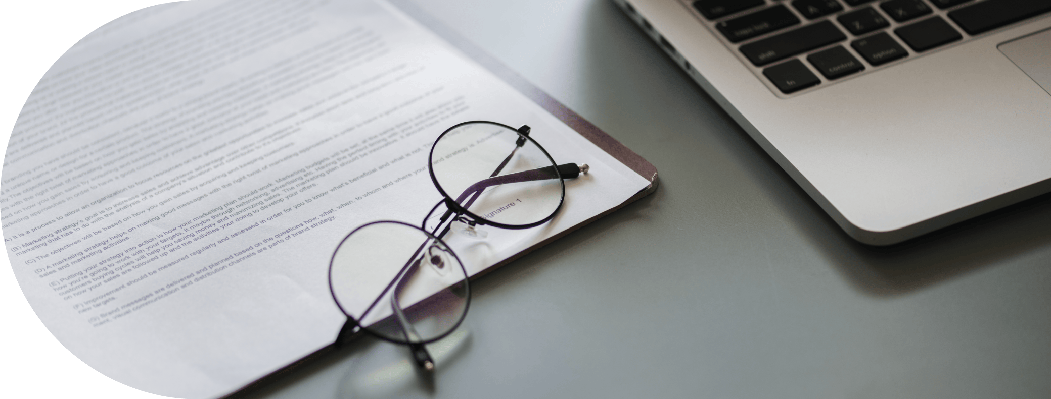 legal papers with glasses and a laptop