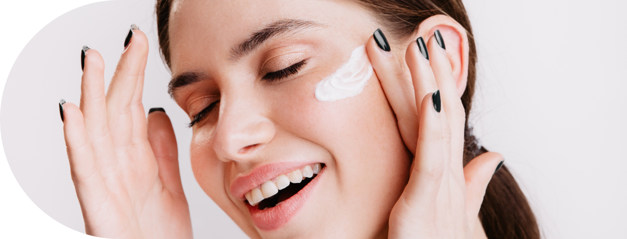 a girl using skincare product on her face