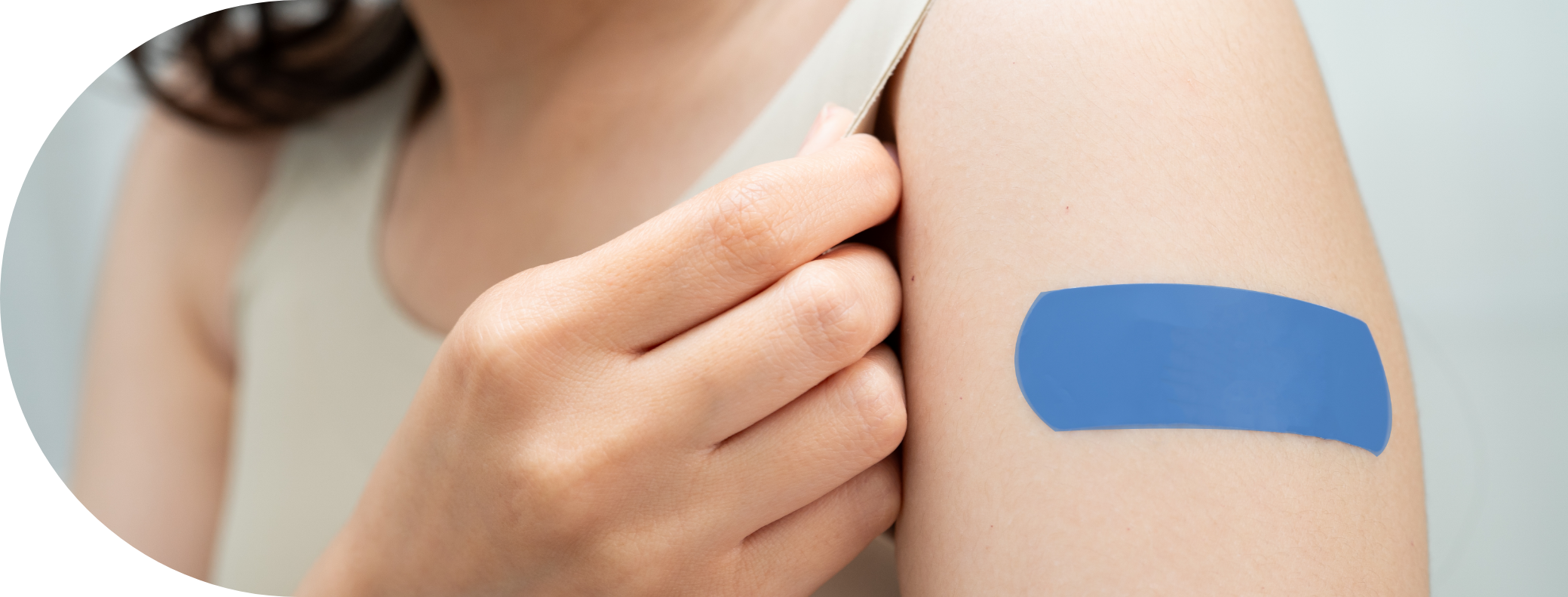 young woman with a plaster on her arm after a vaccination