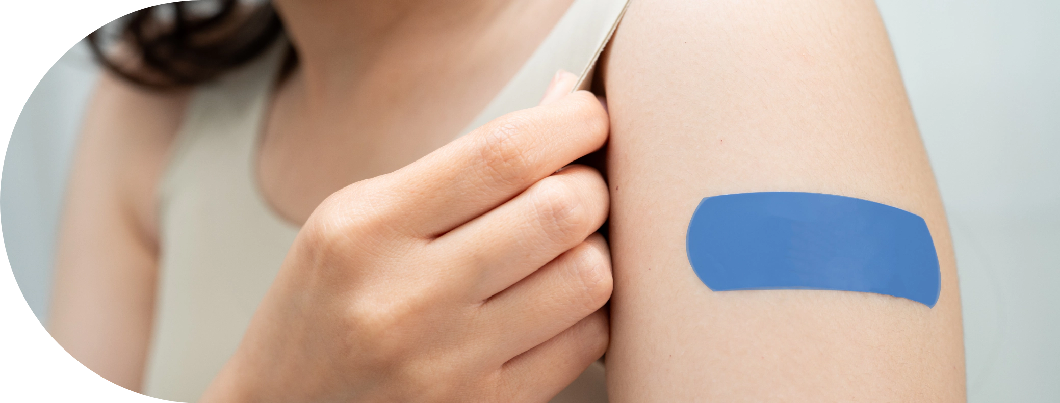 young woman with a plaster on her arm after a vaccination