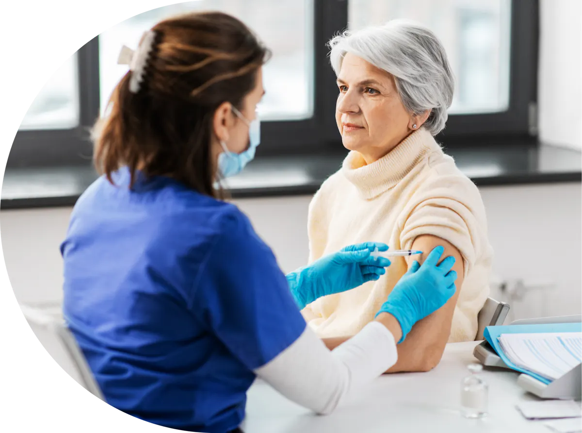 An older lady having a vaccination