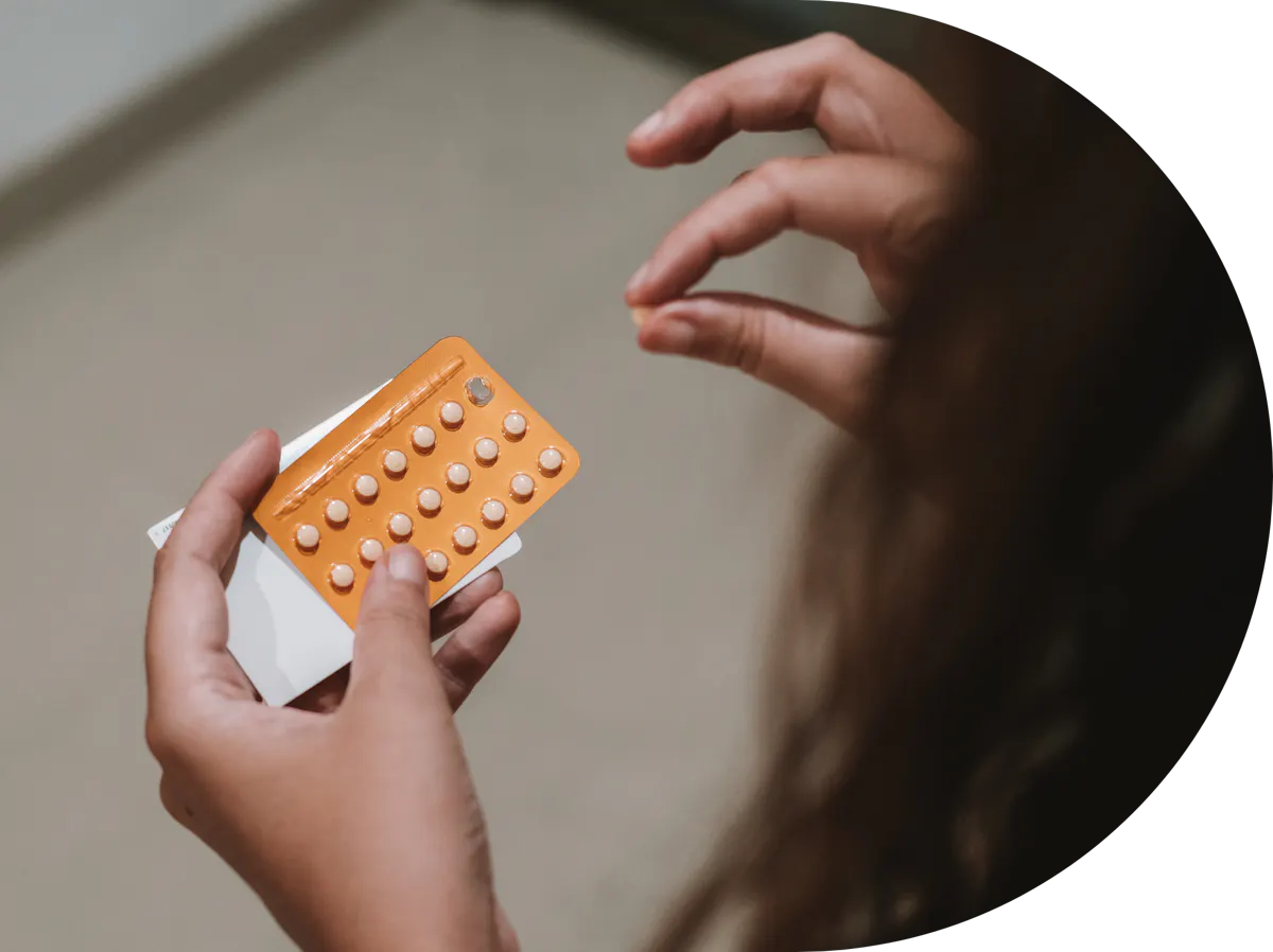 woman taking period delay tablets